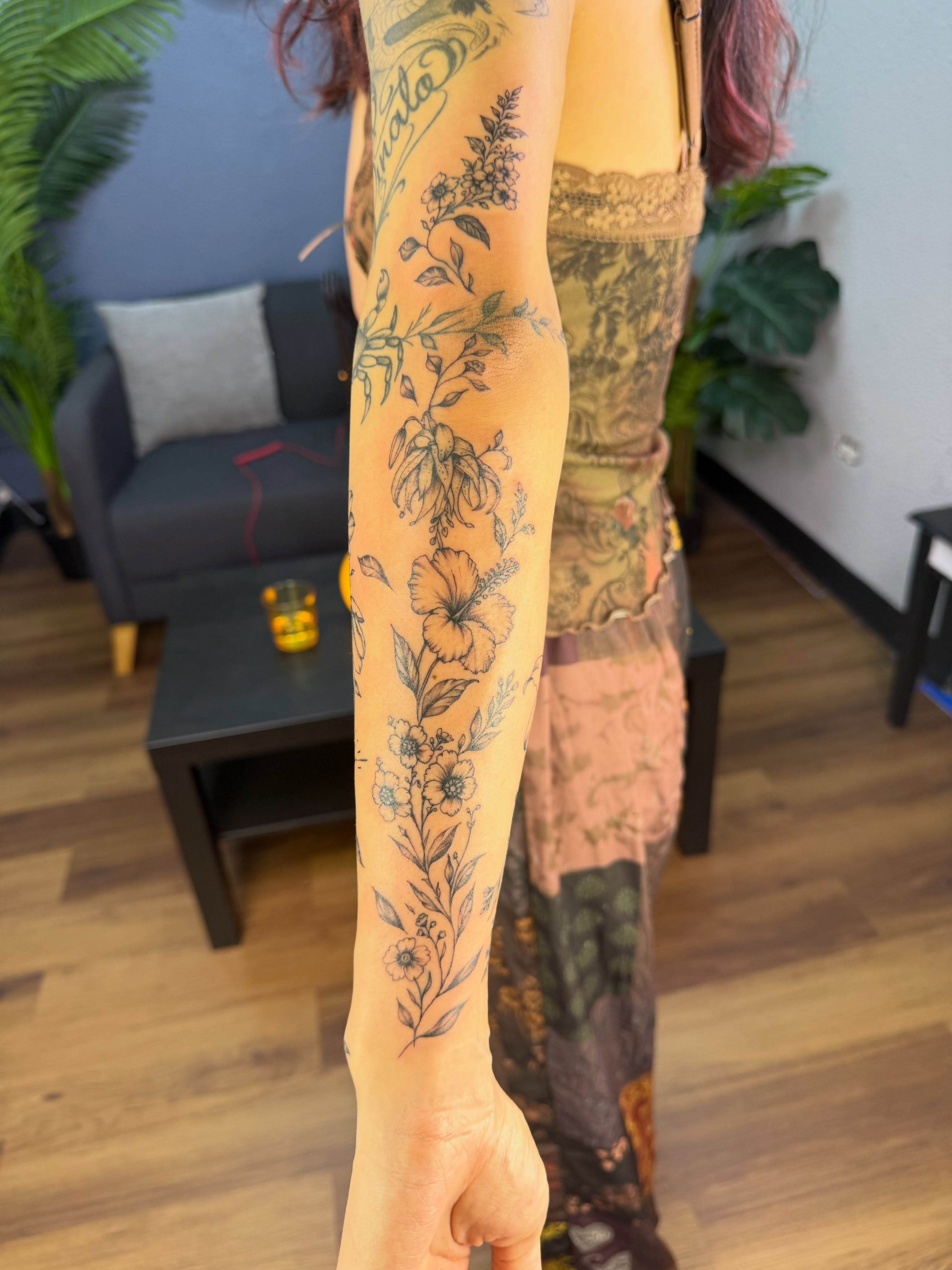 Floral arrangement black and grey tattoo on the forearm by Tetiana