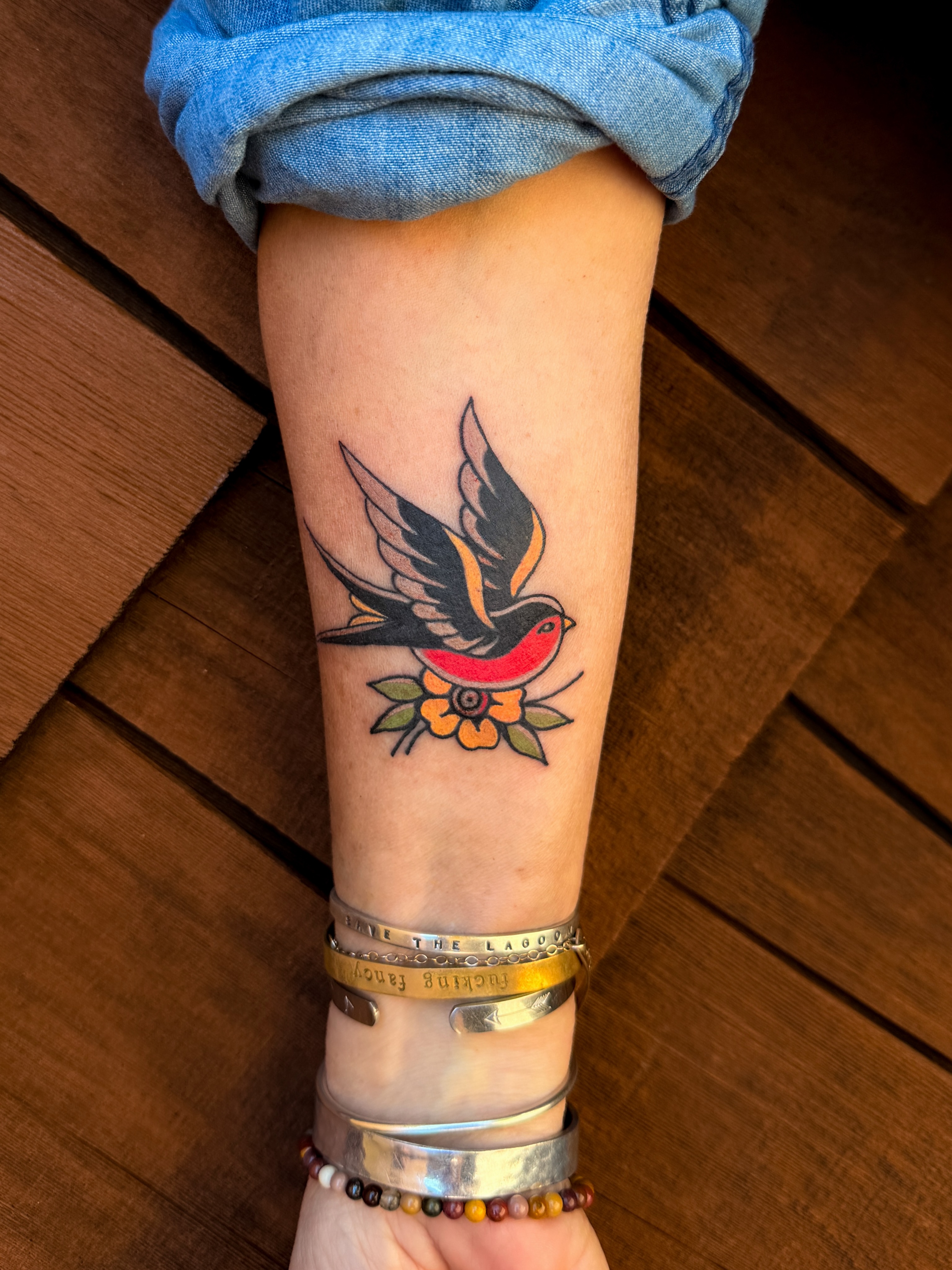 Bird and flower American traditional tattoo on the forearm by Portland Tattoo Artist