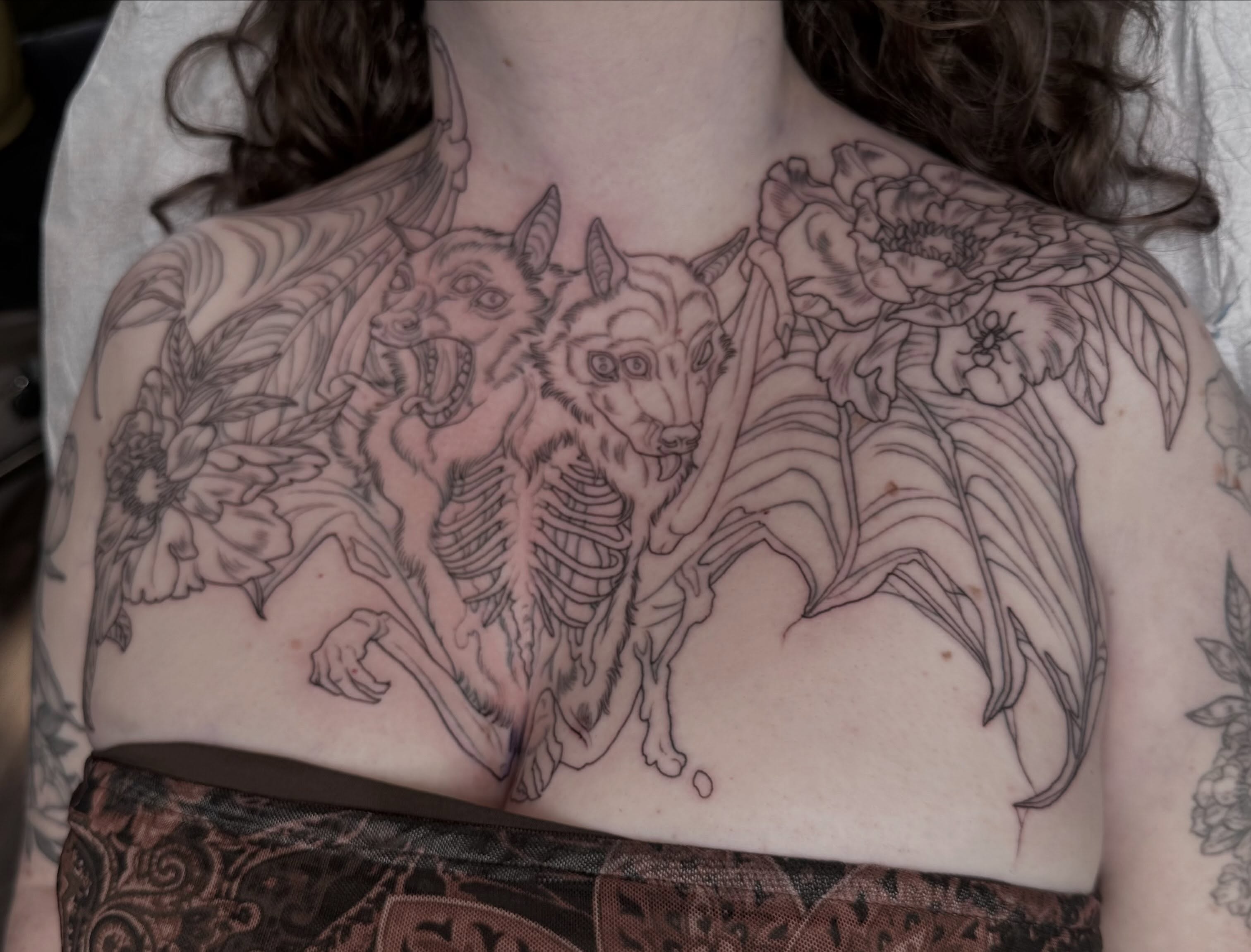 Wolf and flowers realism tattoo on the chest by Cassidy Depew, Seattle, Washington