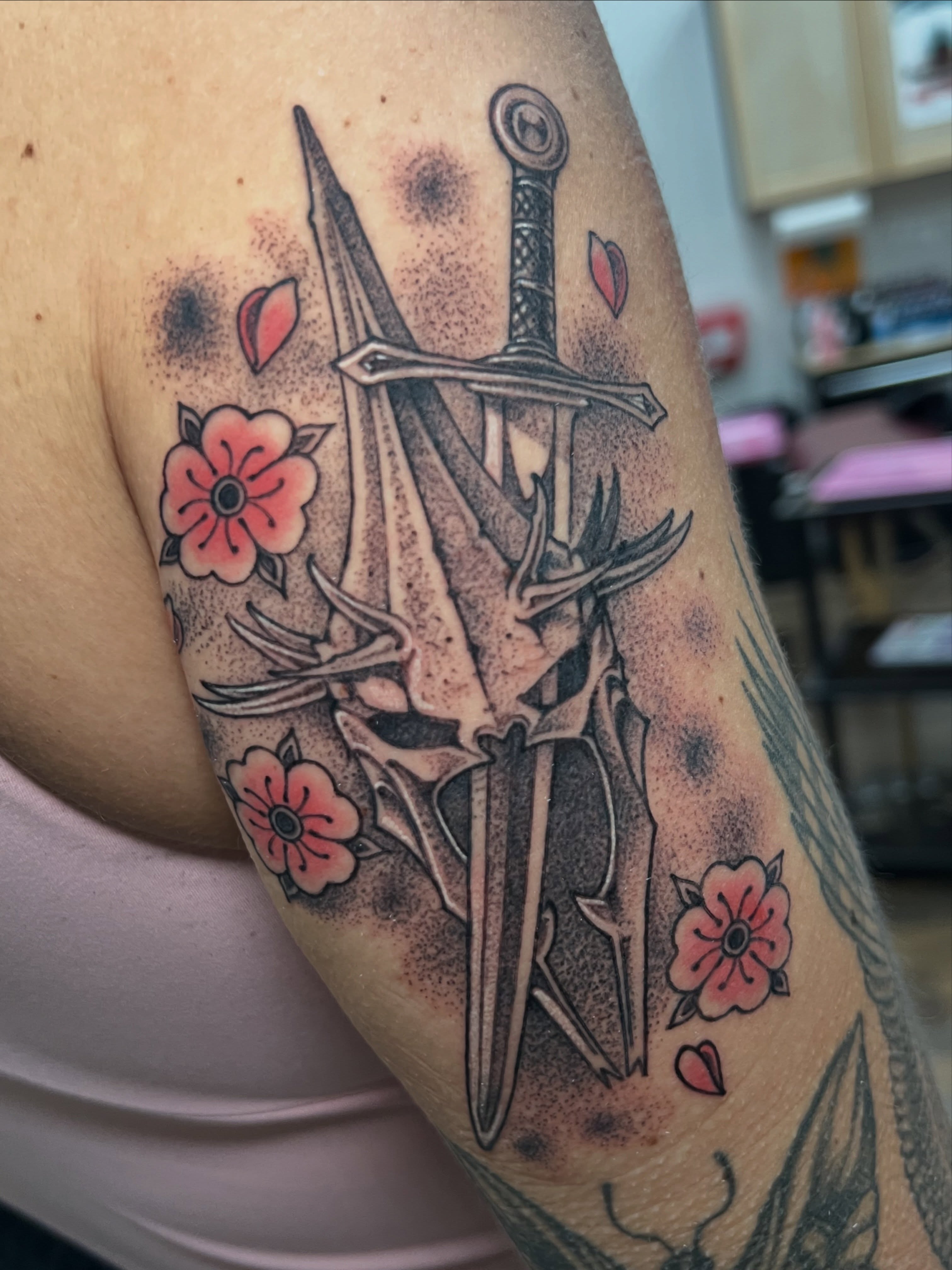 Sword and flowers dotwork tattoo on the forearm by Fredd Chino