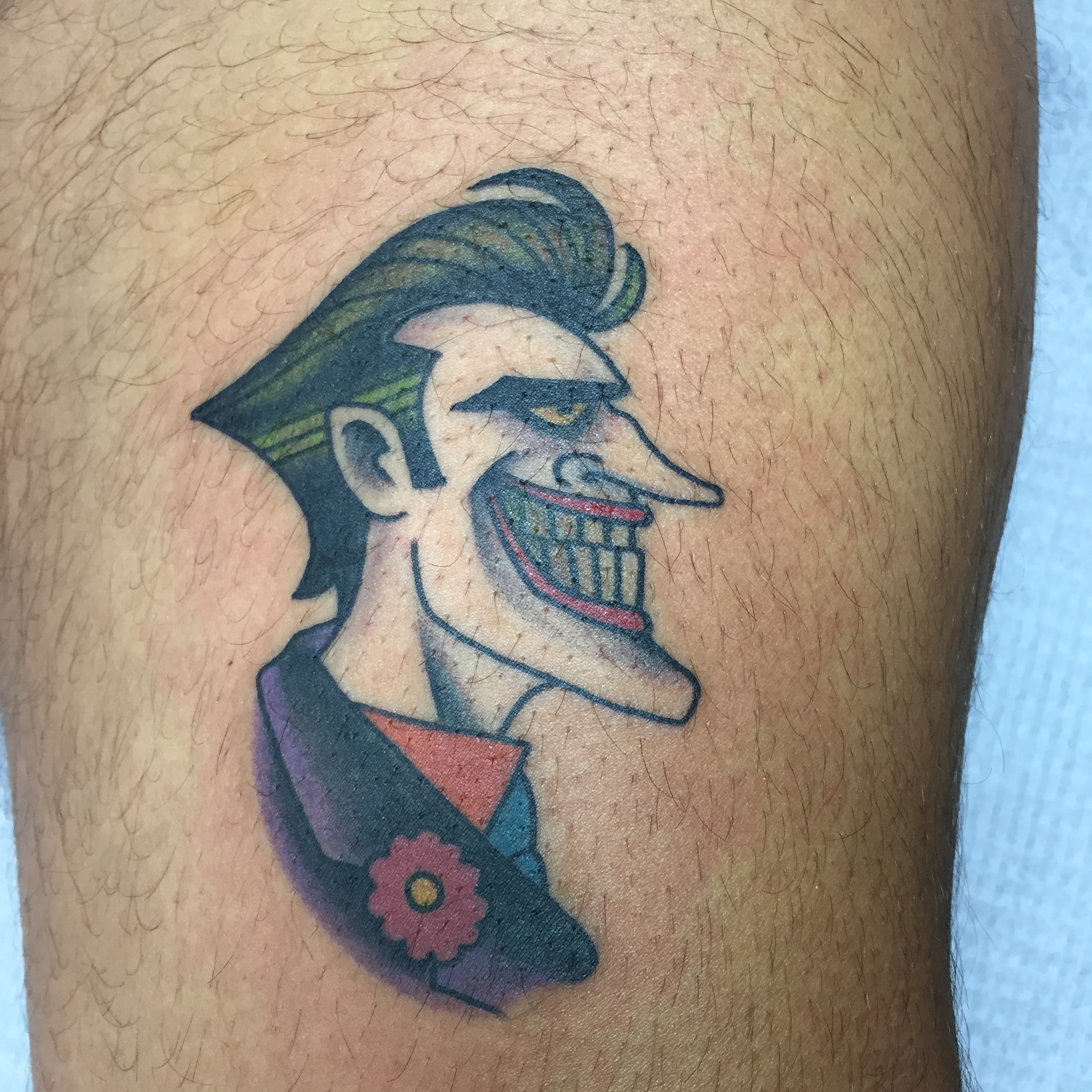 Joker character American traditional tattoo on the thigh by Ramsie Segura-Andrews