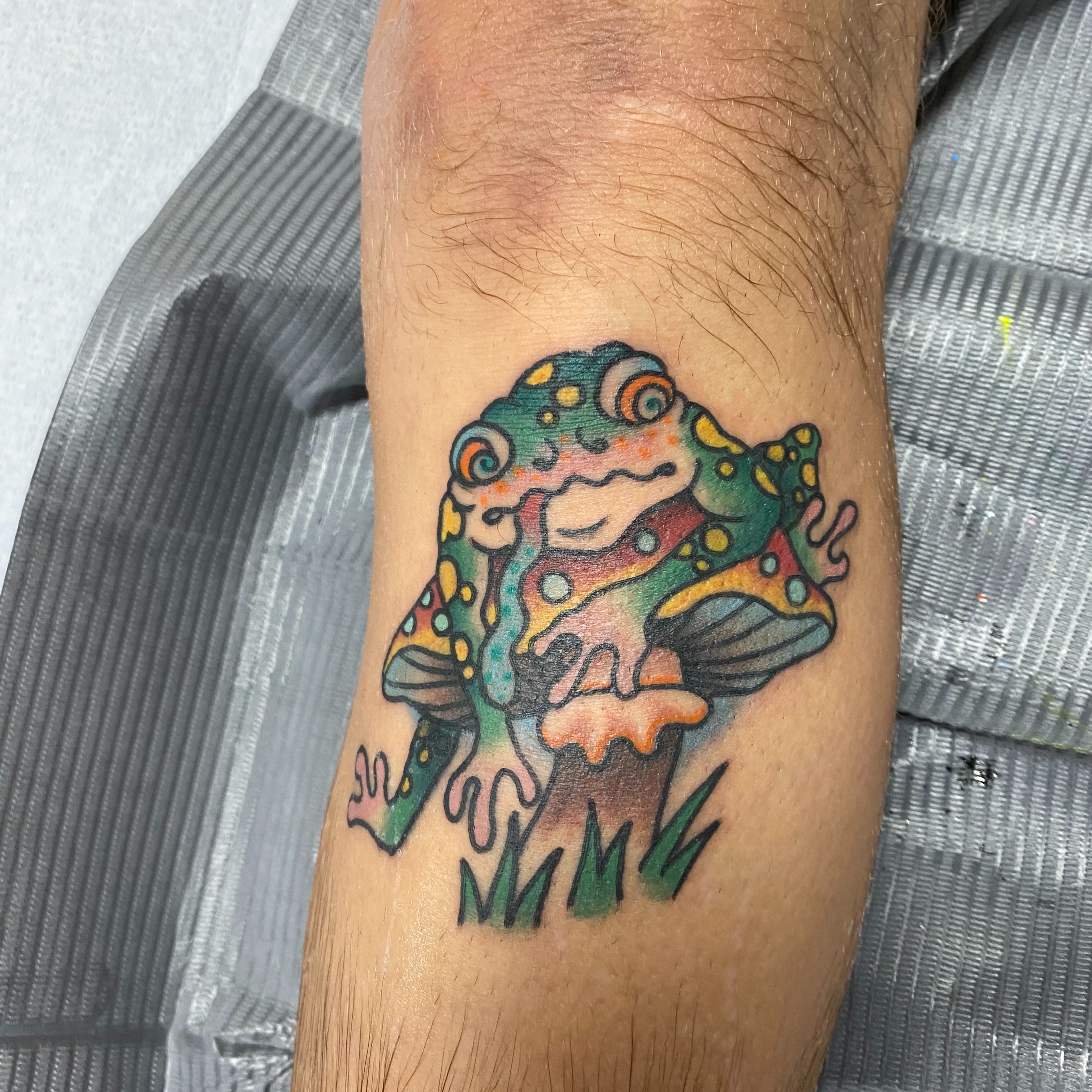 Frog new school tattoo on the forearm by Ramsie Segura-Andrews