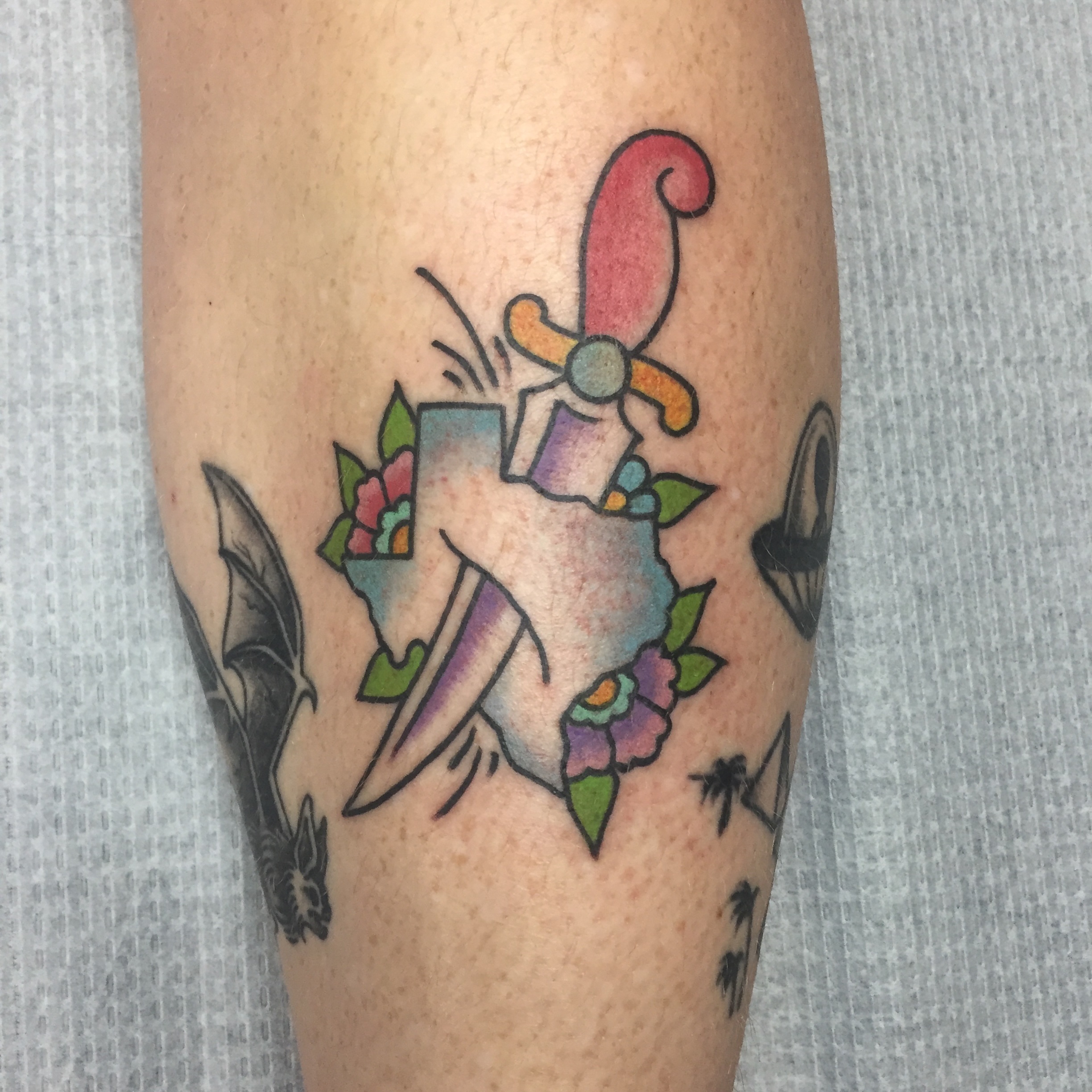 Fan and bouquet American traditional tattoo on the forearm by Ramsie Segura-Andrews