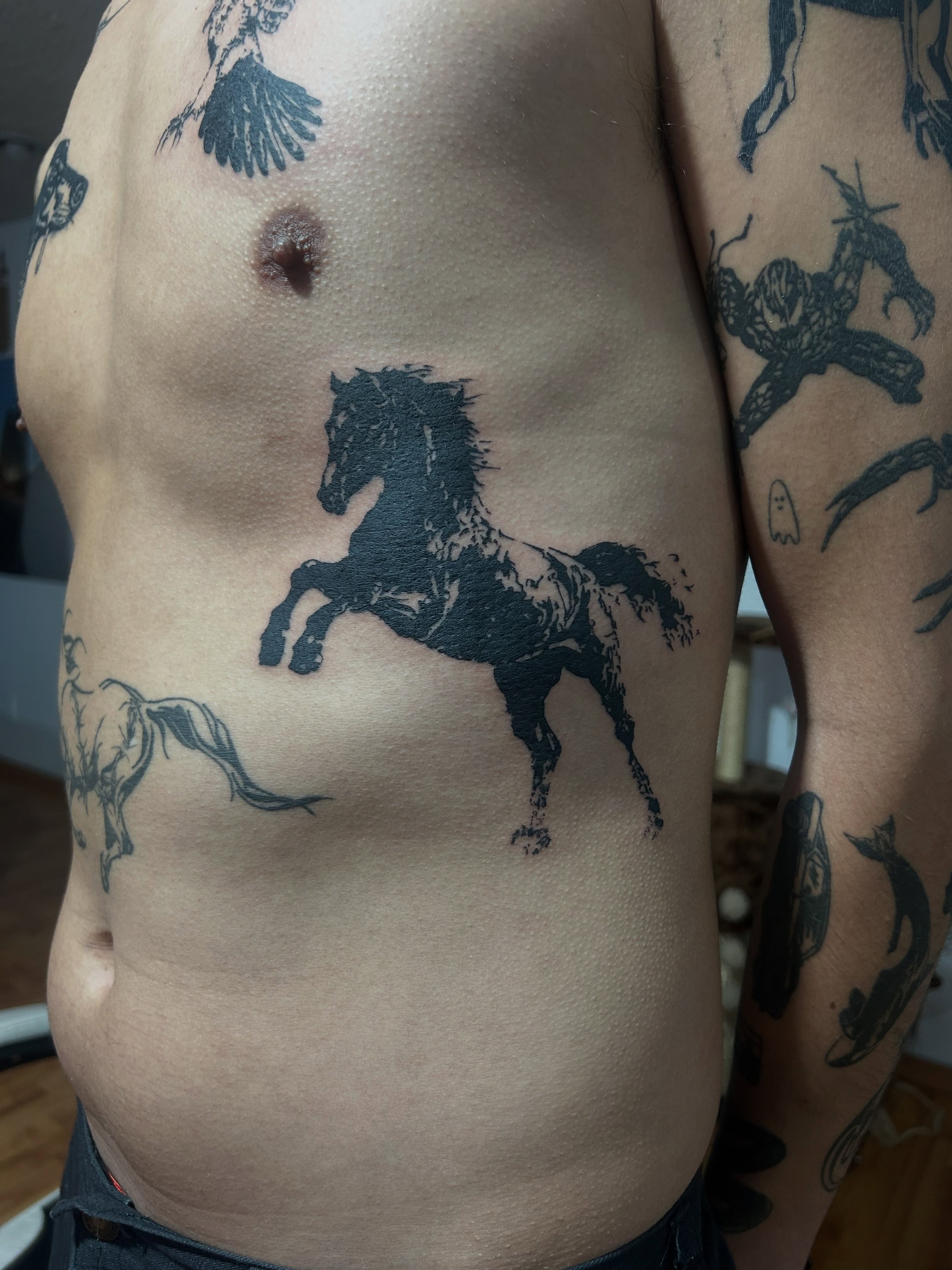 Galloping horse black and grey tattoo on the chest by Barro