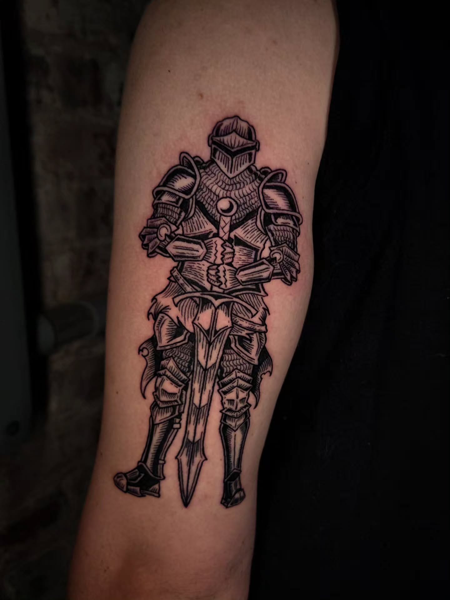 Knight on horseback black and grey tattoo on the forearm by Ian Kiser