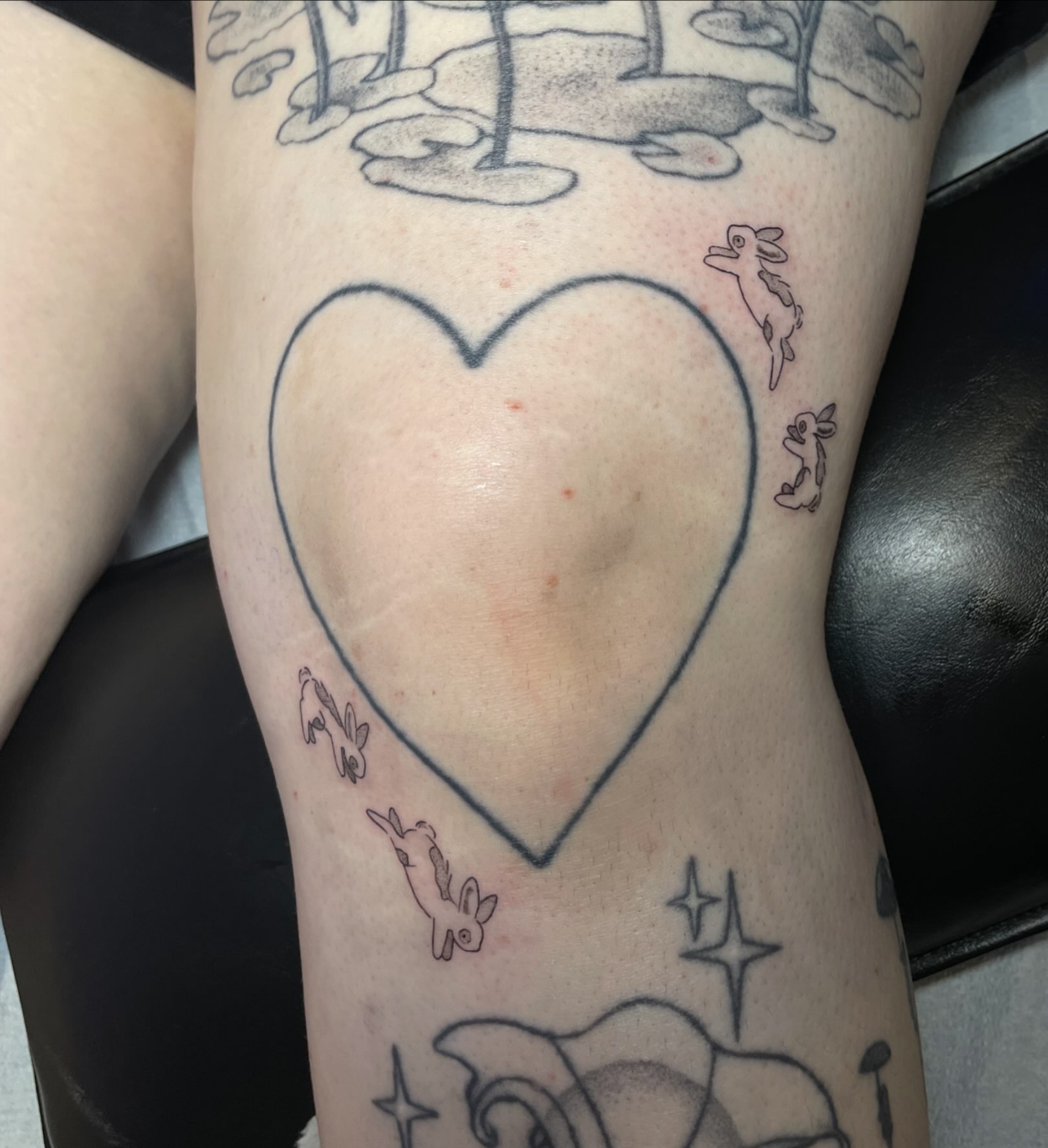Heart with rabbits black and grey tattoo on the forearm by ‧₊˚ ☁️⋅♡ ‧₊