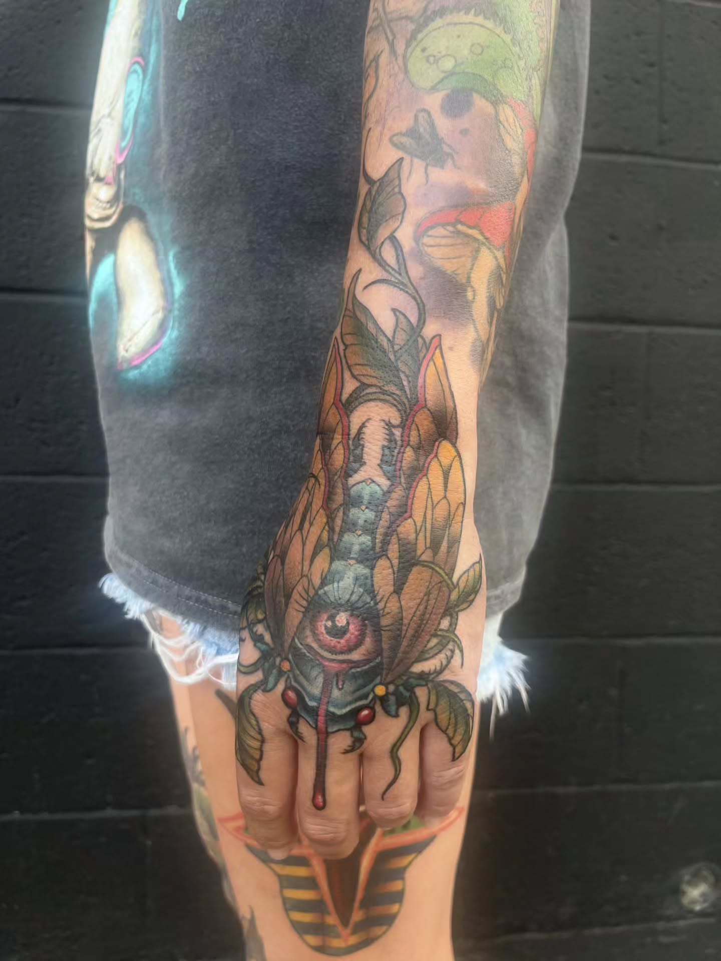 Eye with plant surrealism tattoo on the forearm by Allie Tippets, Gilbert, Arizona