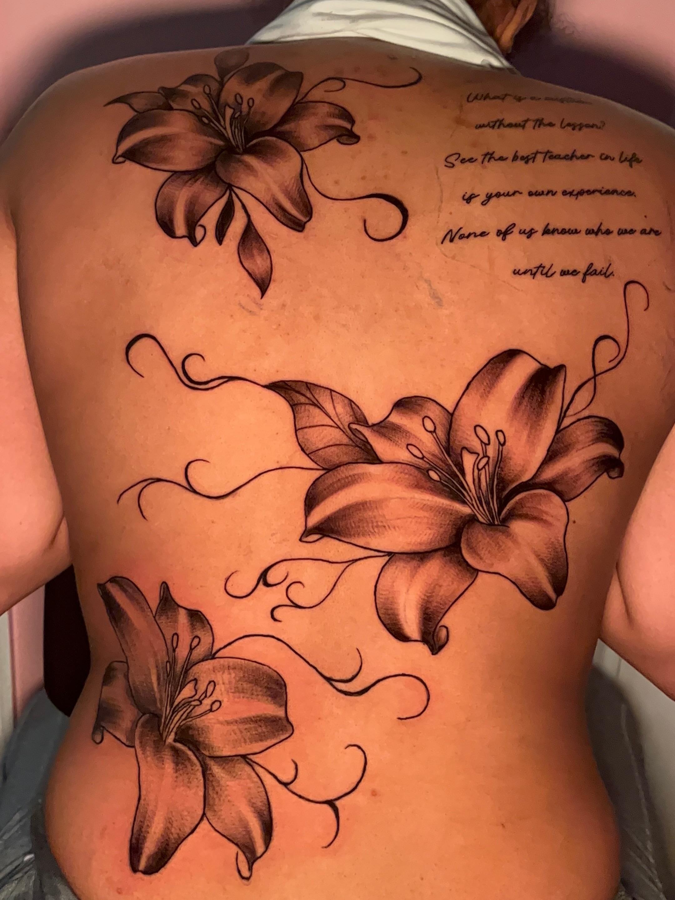 Lilies black and grey tattoo on the back by The inspo