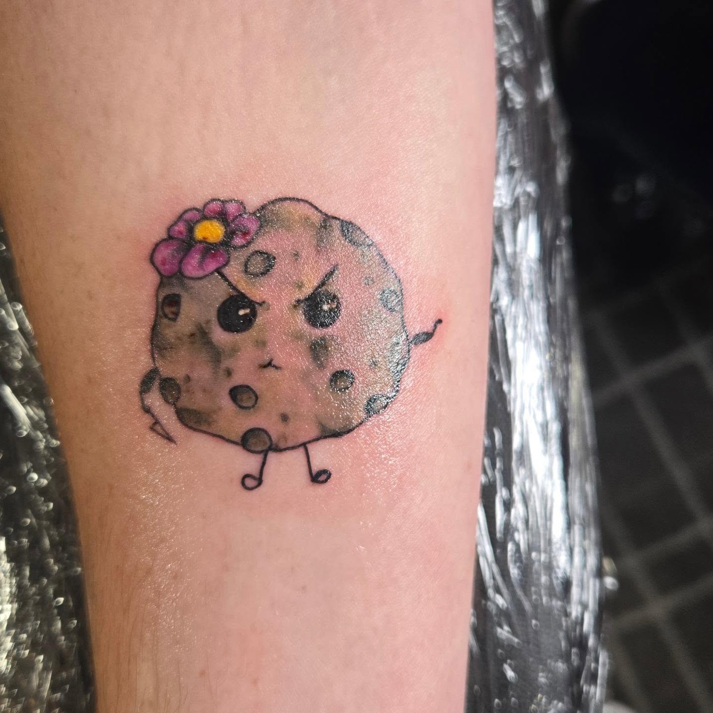 Cookie with flower dotwork tattoo on the forearm by Angel O'Connor Tattoos