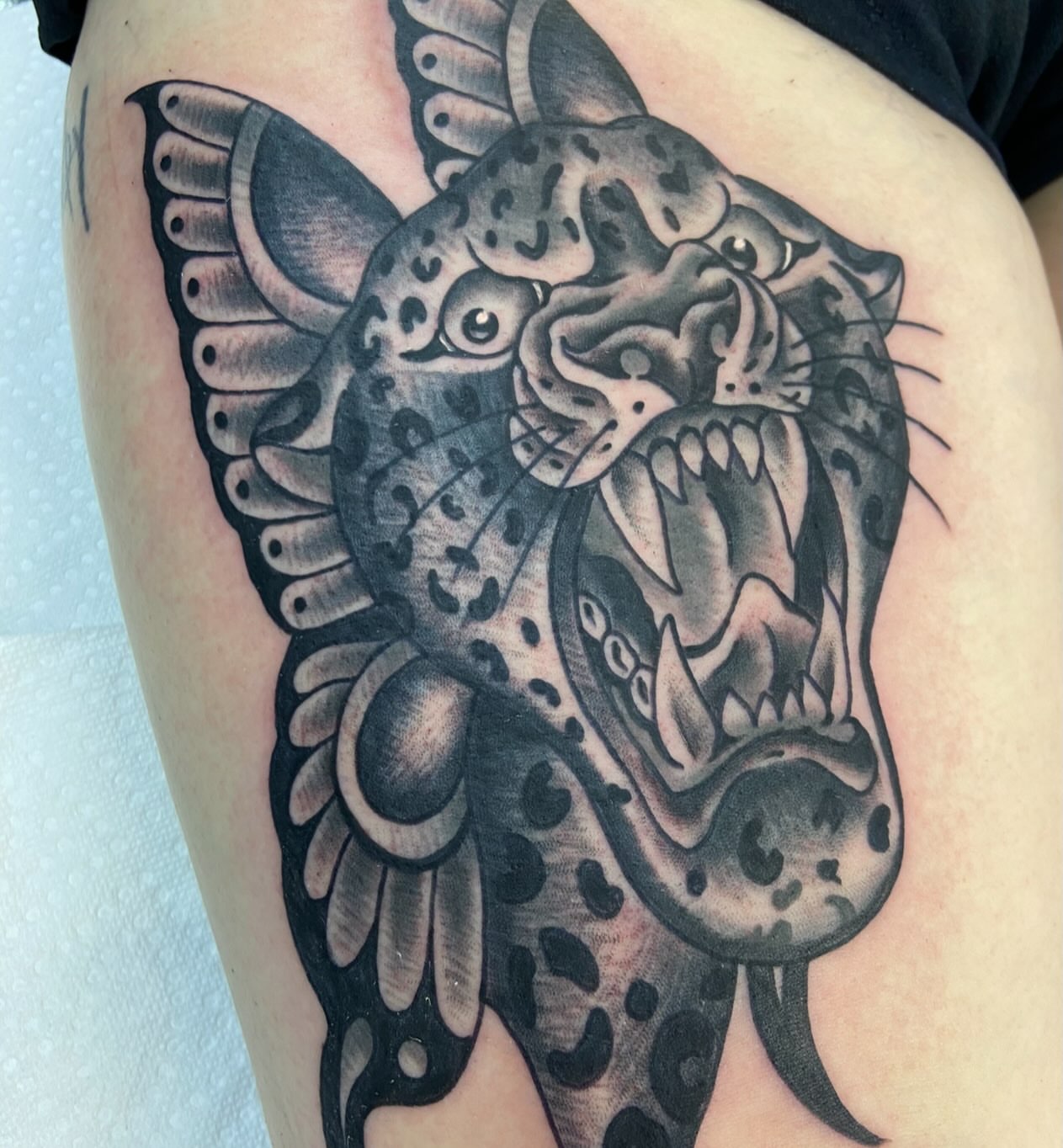 Jaguar black and grey tattoo on the thigh by Dylan O'Quin