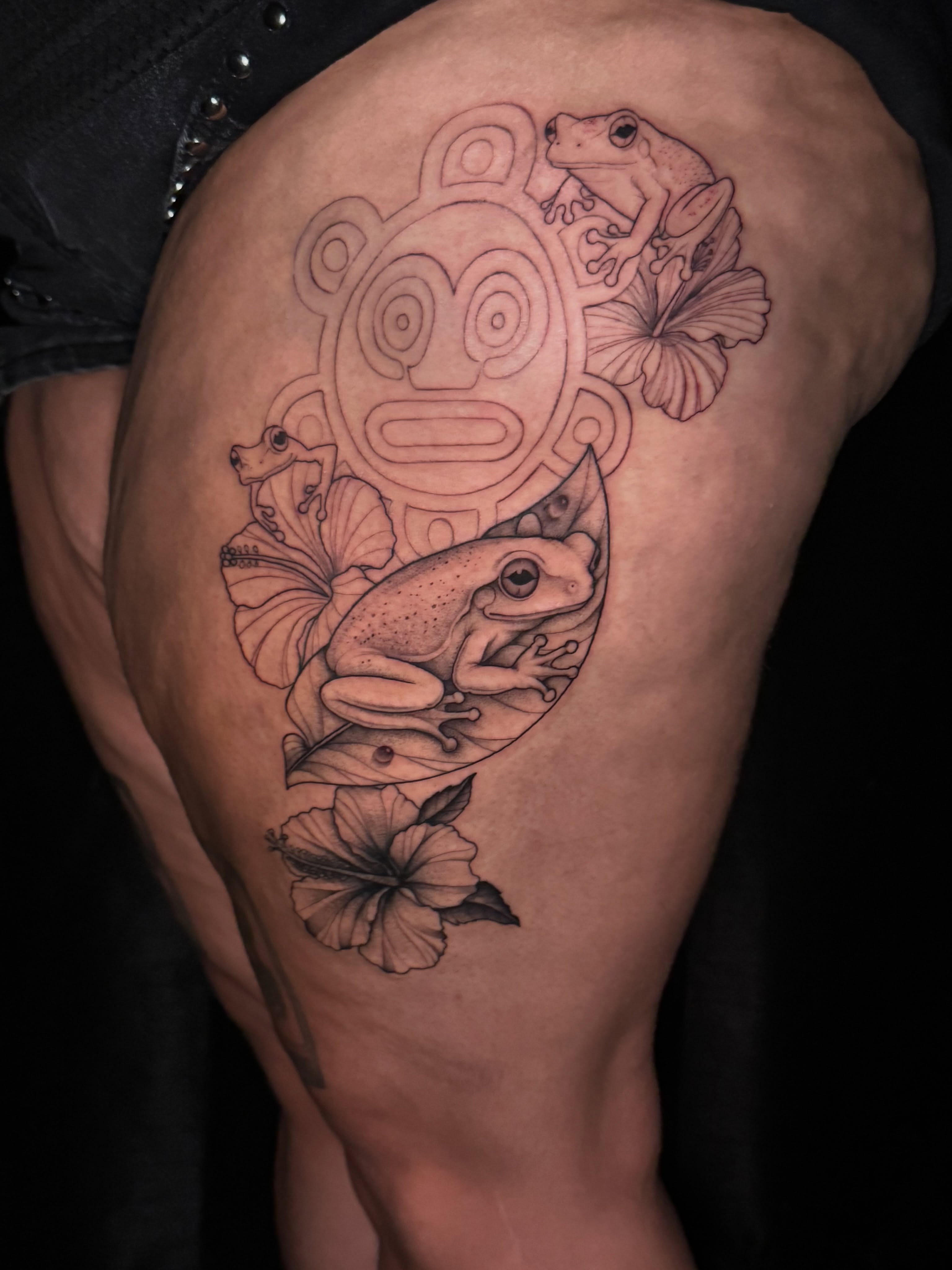 Frogs and hibiscus flowers realism tattoo on the thigh by North County Sd