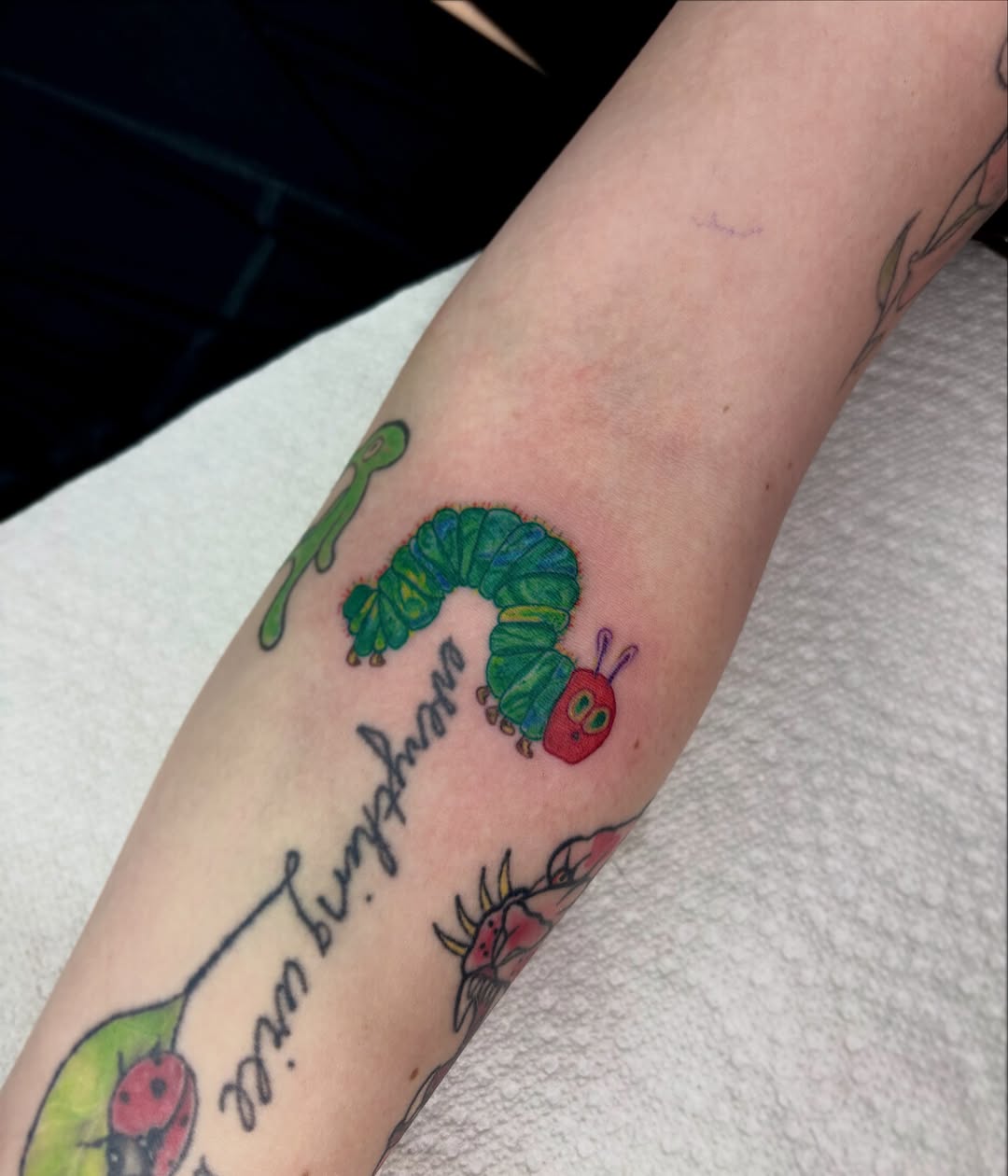 Worm new school tattoo on the forearm by destiney rose