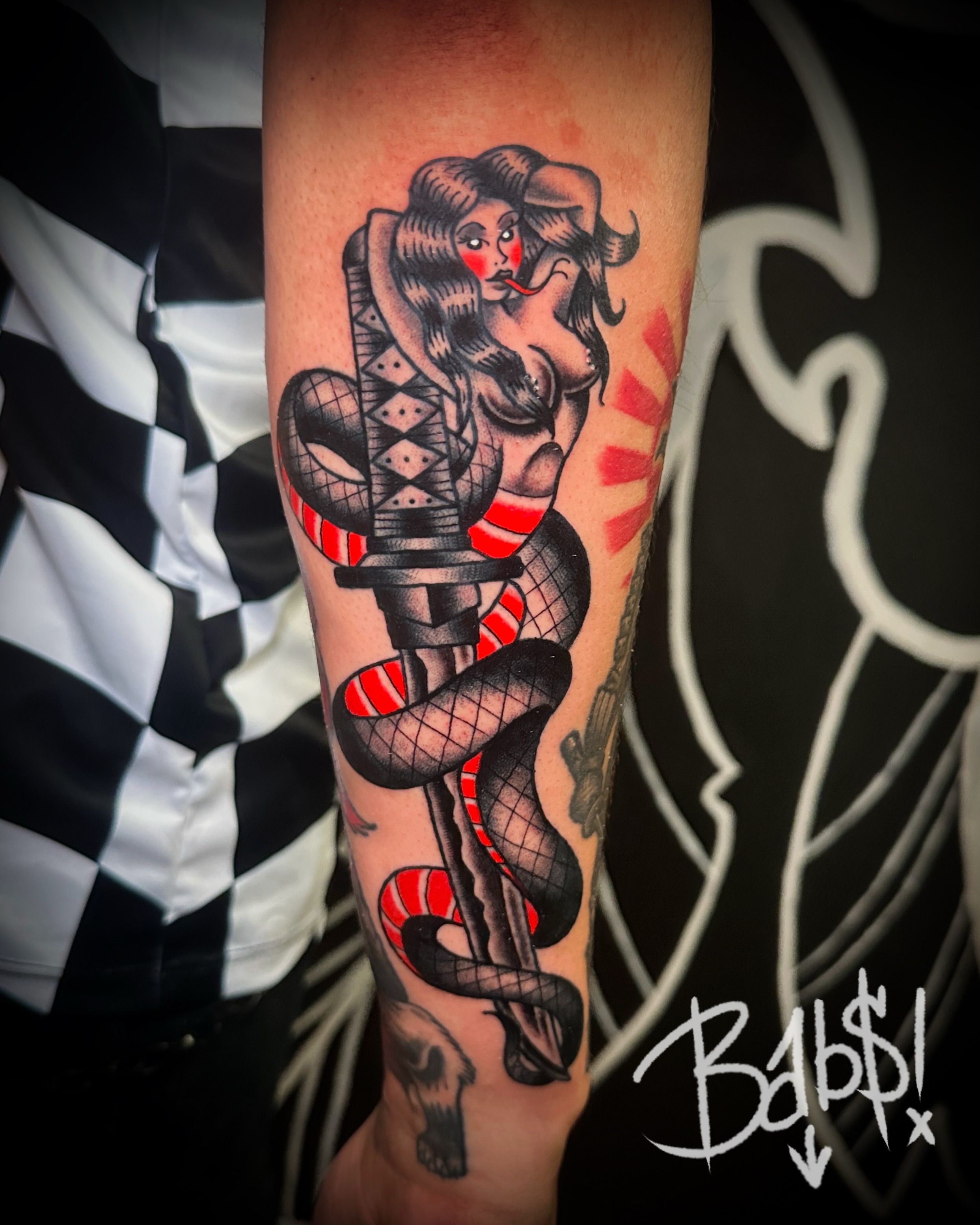 Woman with snake American traditional tattoo on the forearm by Justin B