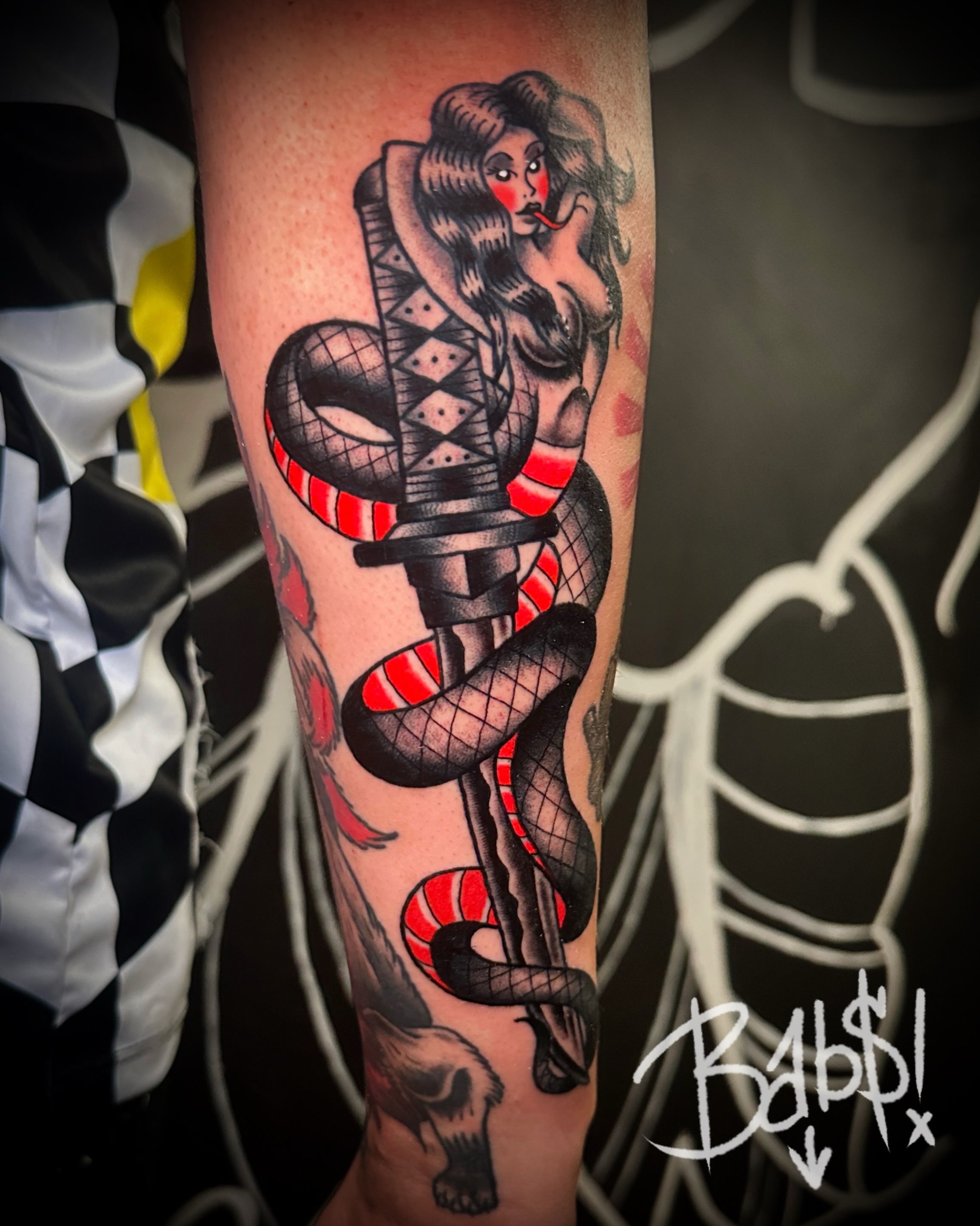 Woman with snake American traditional tattoo on the forearm by Justin B