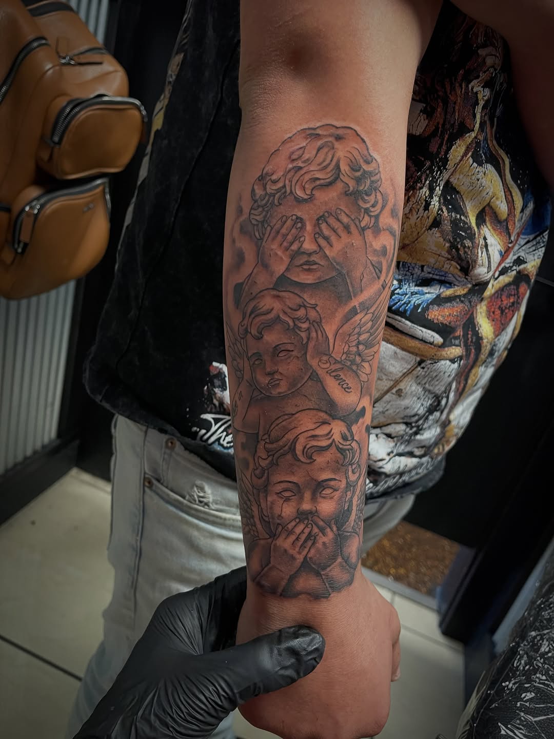 Cherubs realism tattoo on the forearm by Chris Torres