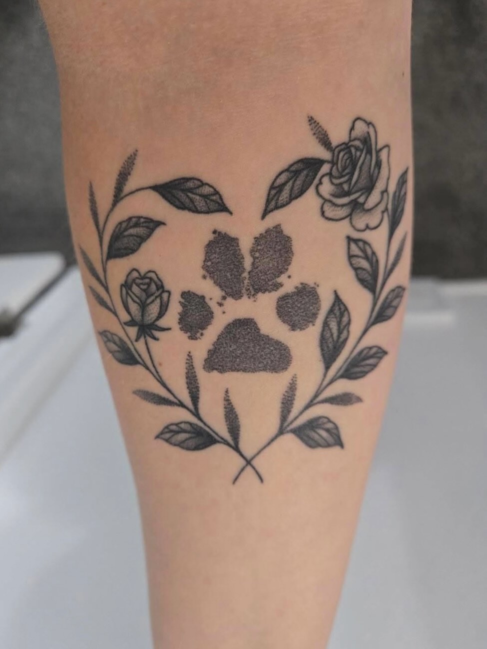 Paw print with floral wreath dotwork tattoo on the forearm by 𝖆𝖑𝖞𝖘𝖘𝖆 ☽