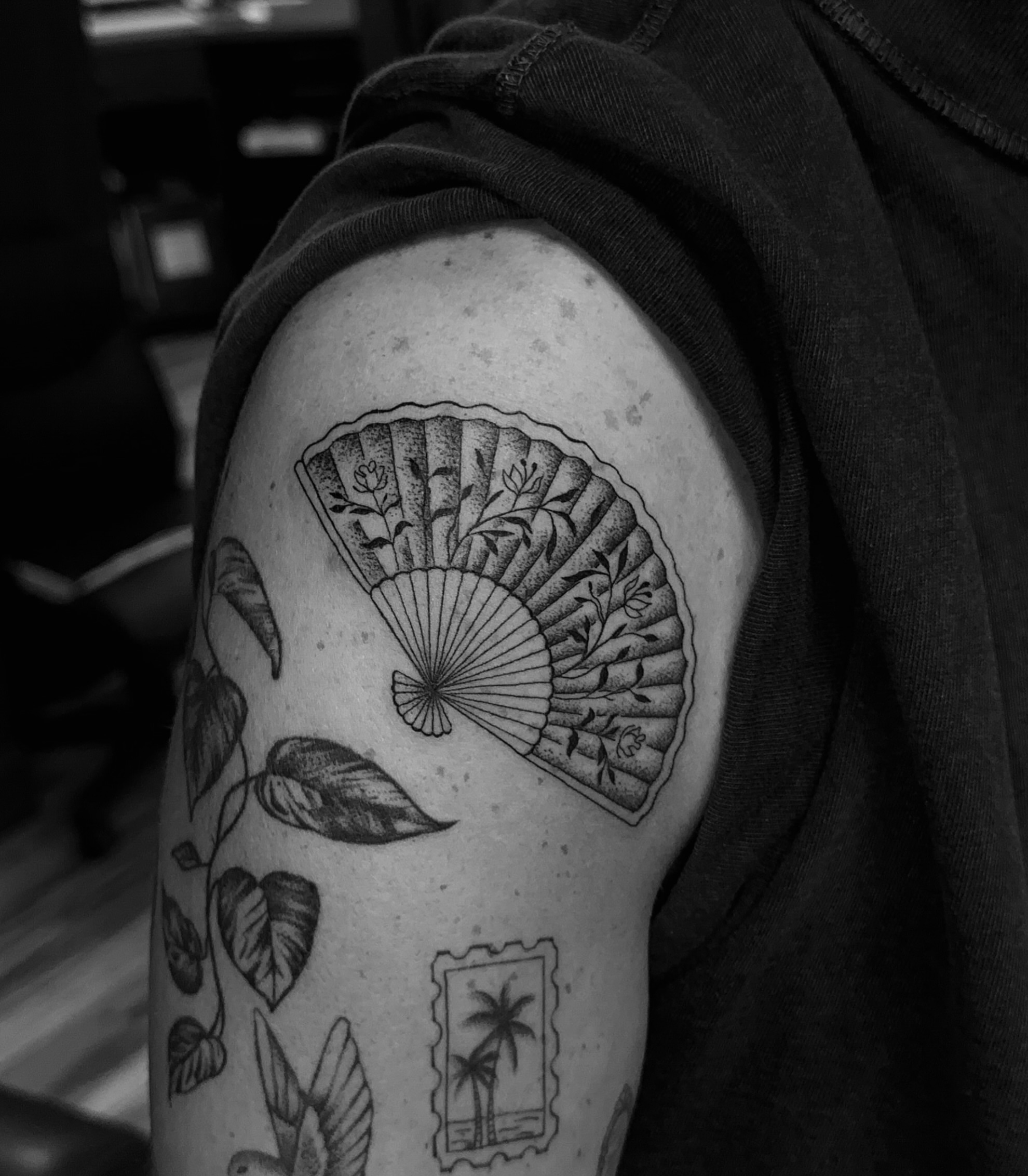 Fan and leaves ornamental tattoo on the shoulder by Leo Fernandes, Danvers, Massachusetts