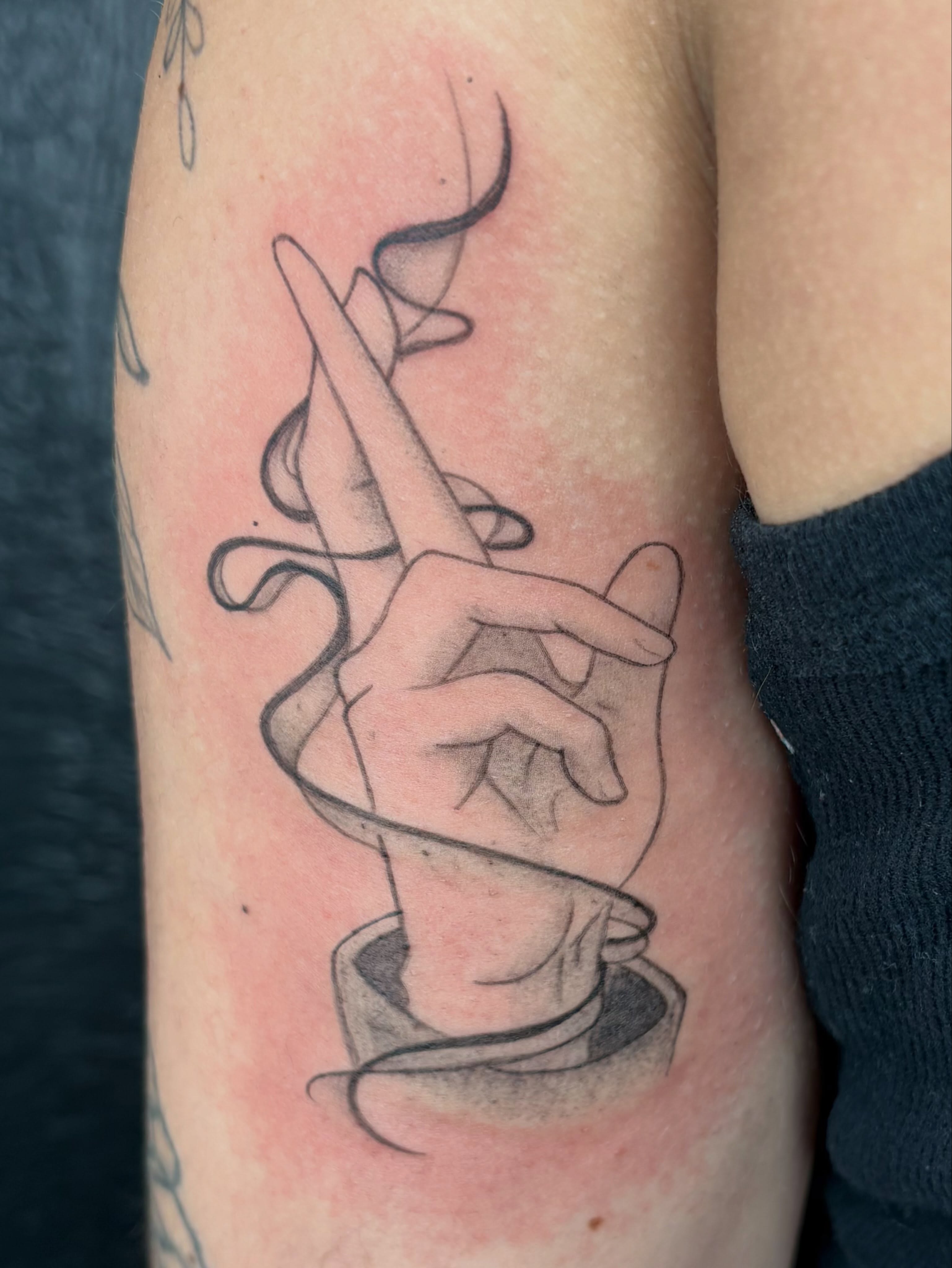 Hand with string black and grey tattoo on the forearm by Sierra Maynard