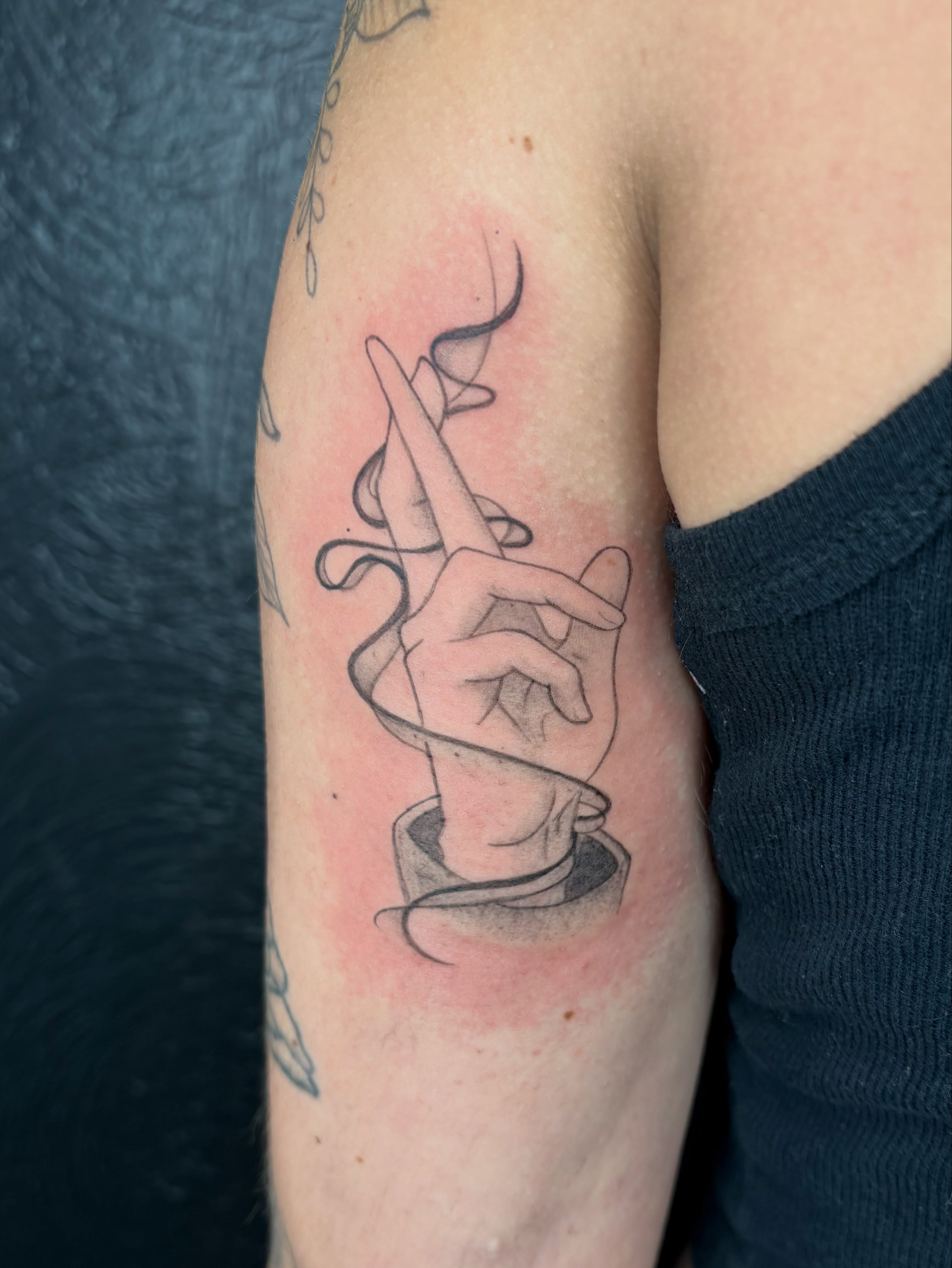 Hand with string black and grey tattoo on the forearm by Sierra Maynard