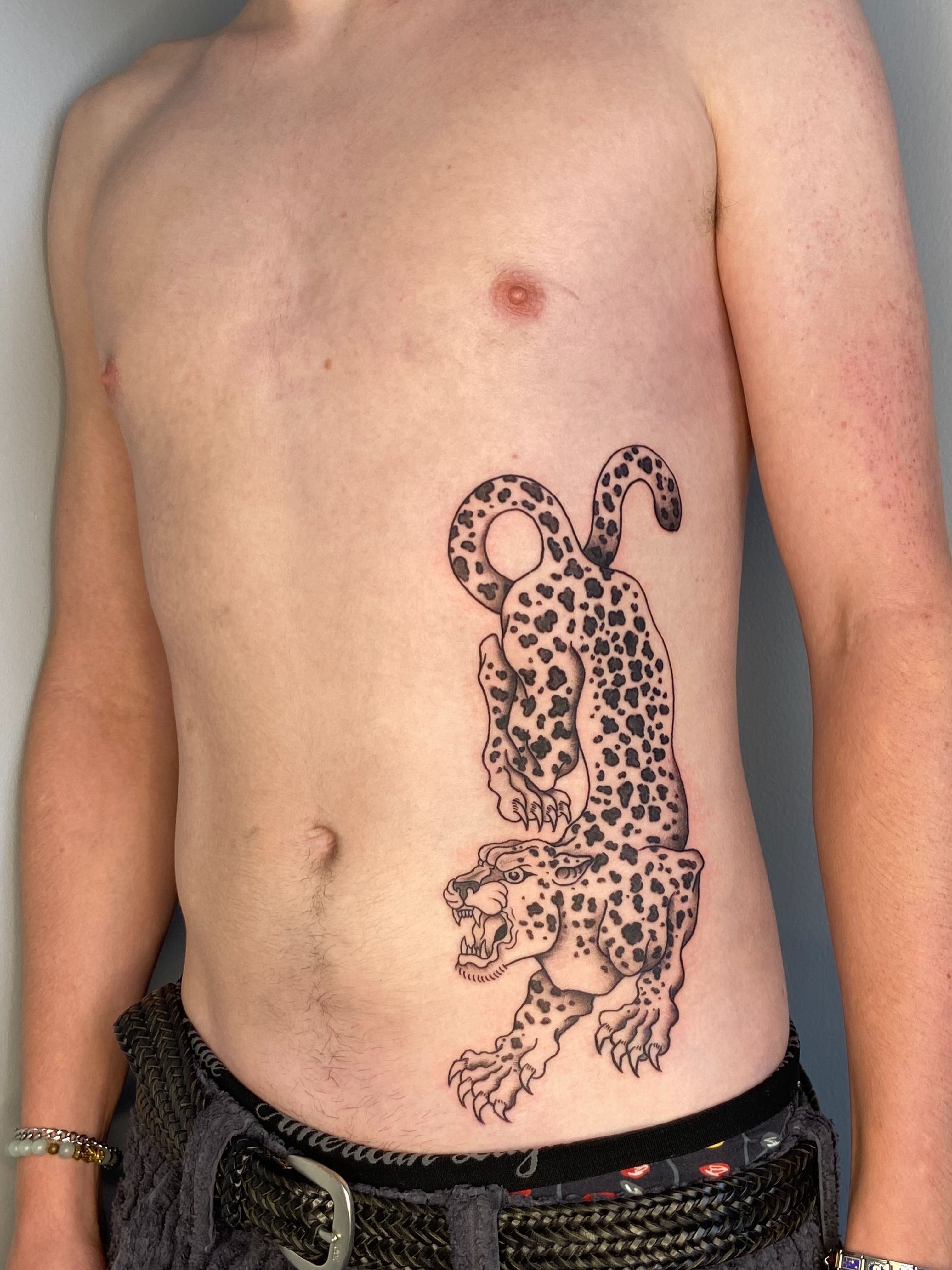 Leopard black and grey tattoo on the ribs by Derek Krueger Portland Tattoo Artist, Portland, Oregon