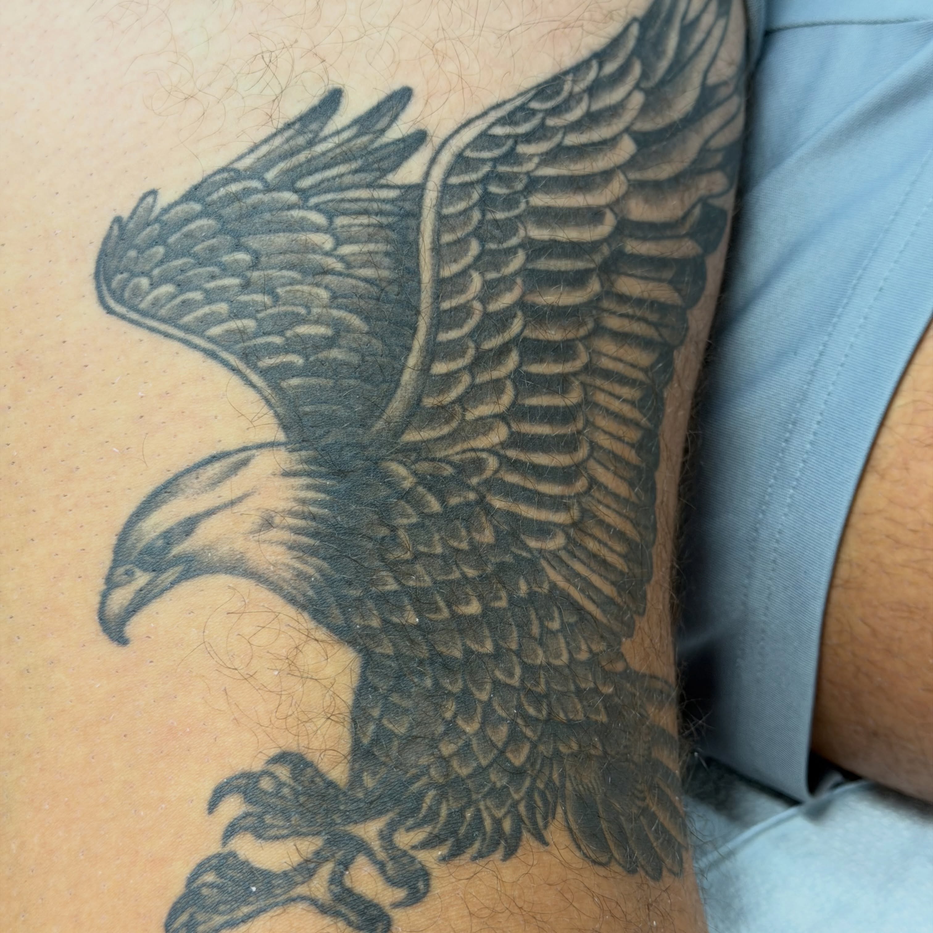 Eagle black and grey tattoo on the thigh by Squid