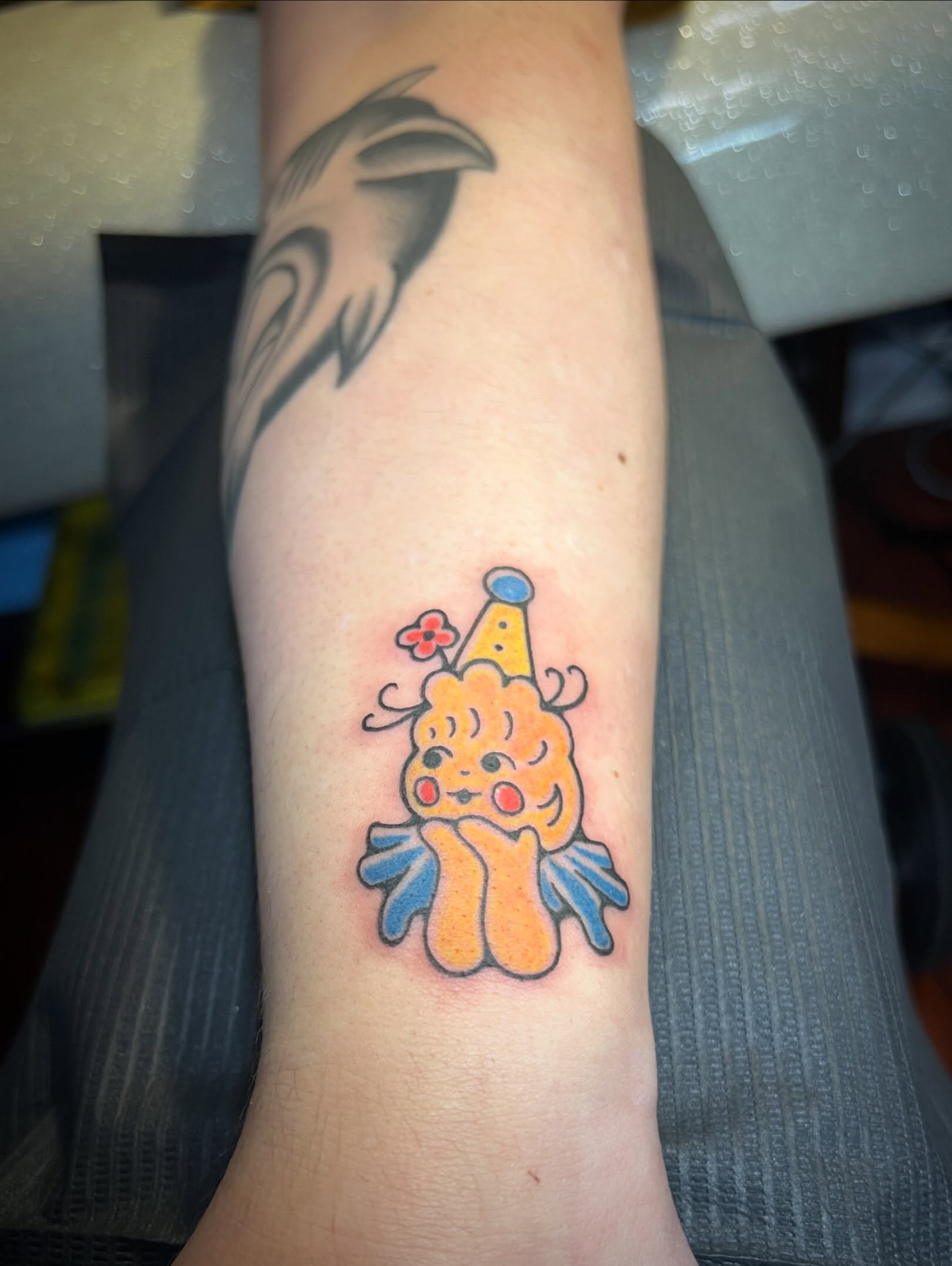 Clown new school tattoo on the forearm by Tattoo Kayla