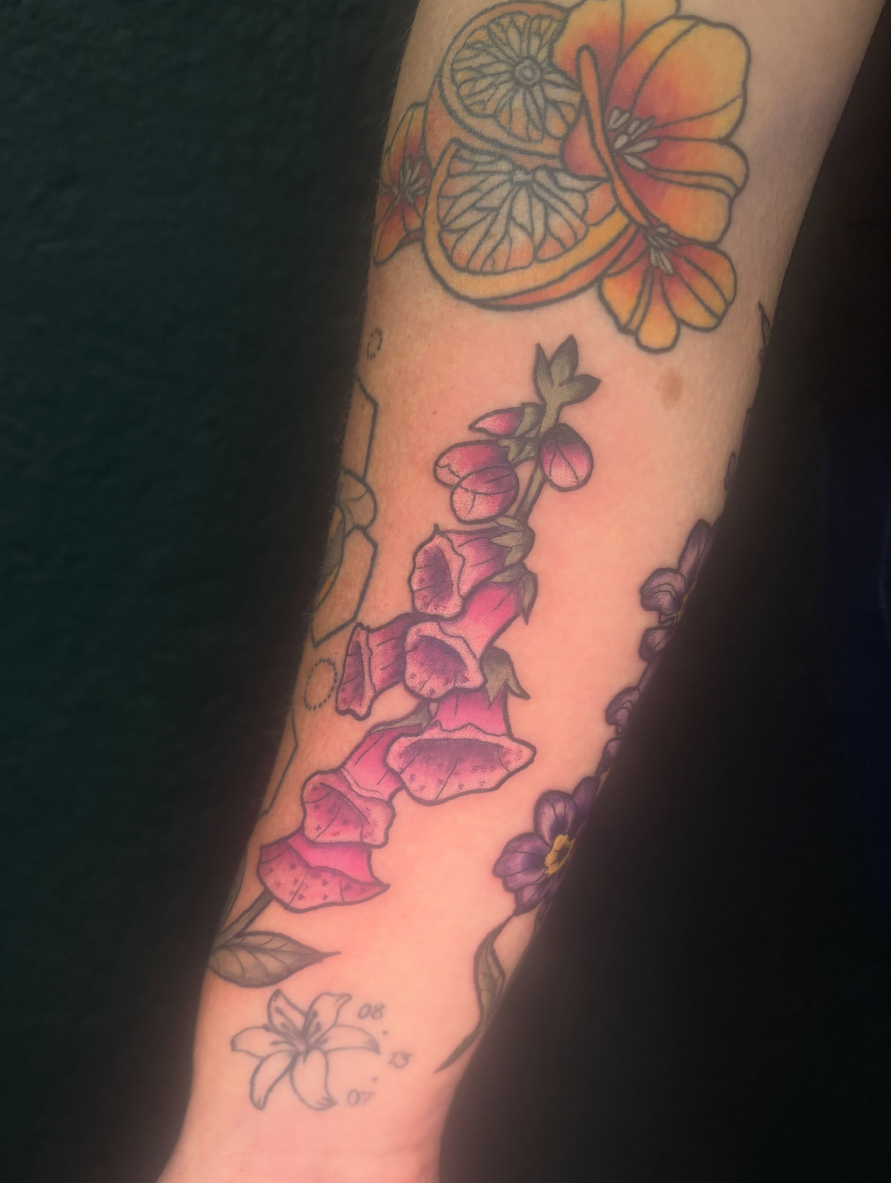 Flowers and citrus new school tattoo on the forearm by Emma ๐