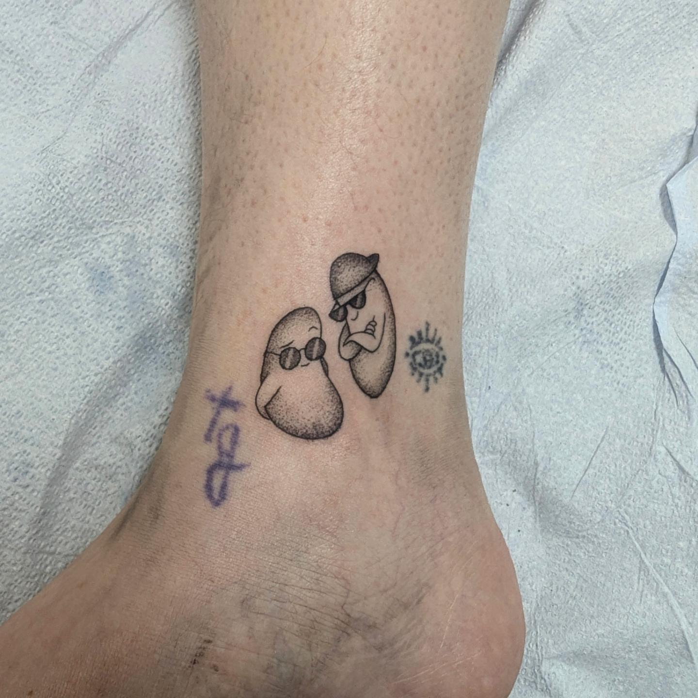 Two characters with sun dotwork tattoo on the foot by DONEL 📍Denver