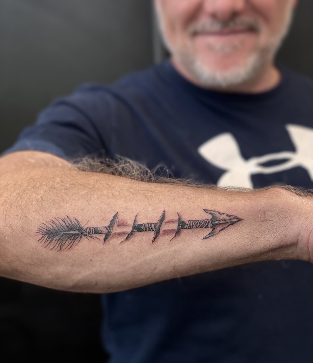 Arrow black and grey tattoo on the forearm by abbie michelle