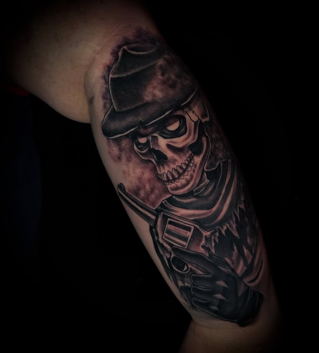 Skull with fedora dark realism tattoo on the forearm by Savannah Duff