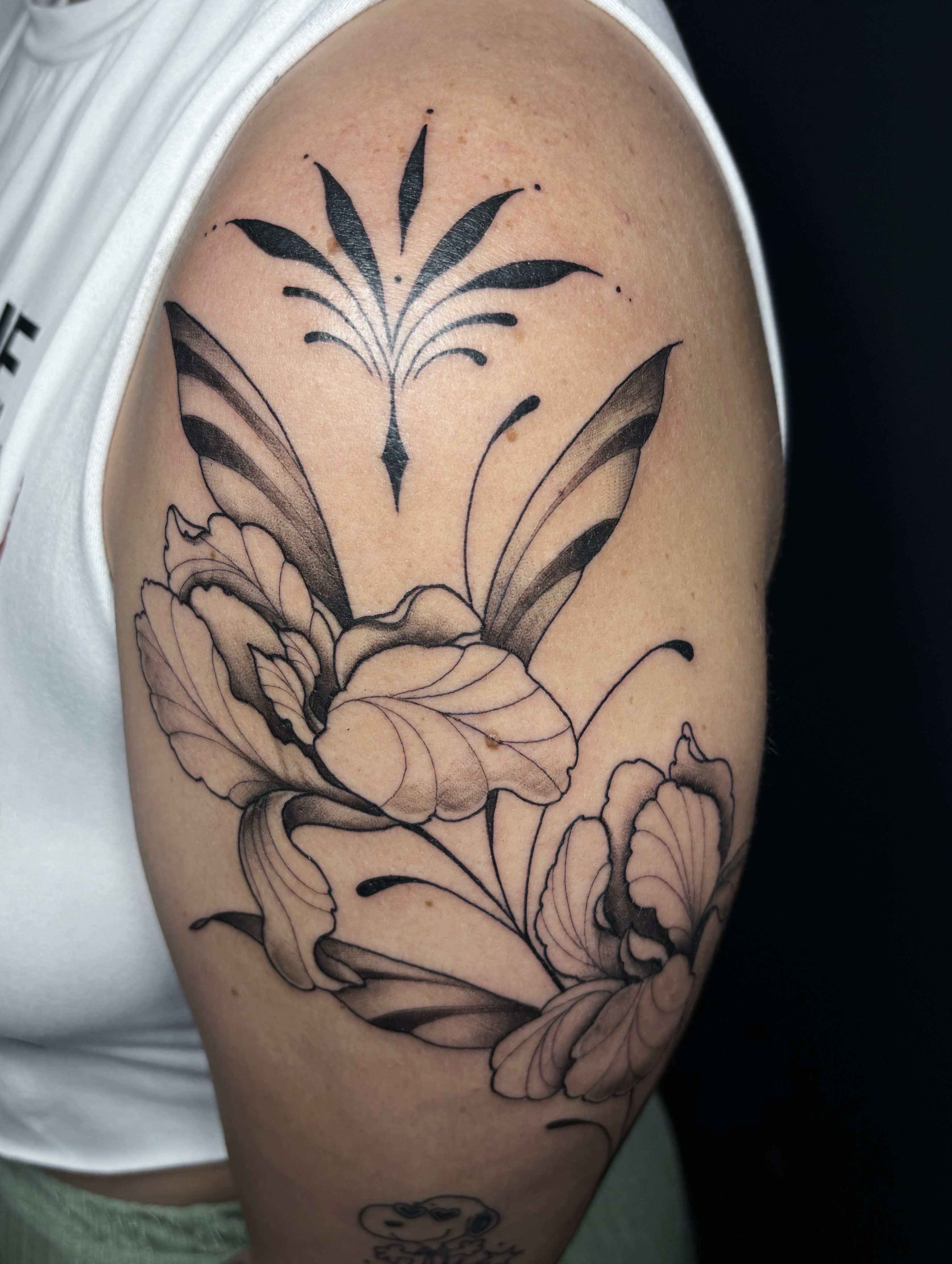 Lily and peony realism tattoo on the shoulder by Fine Line Tattoo Artist