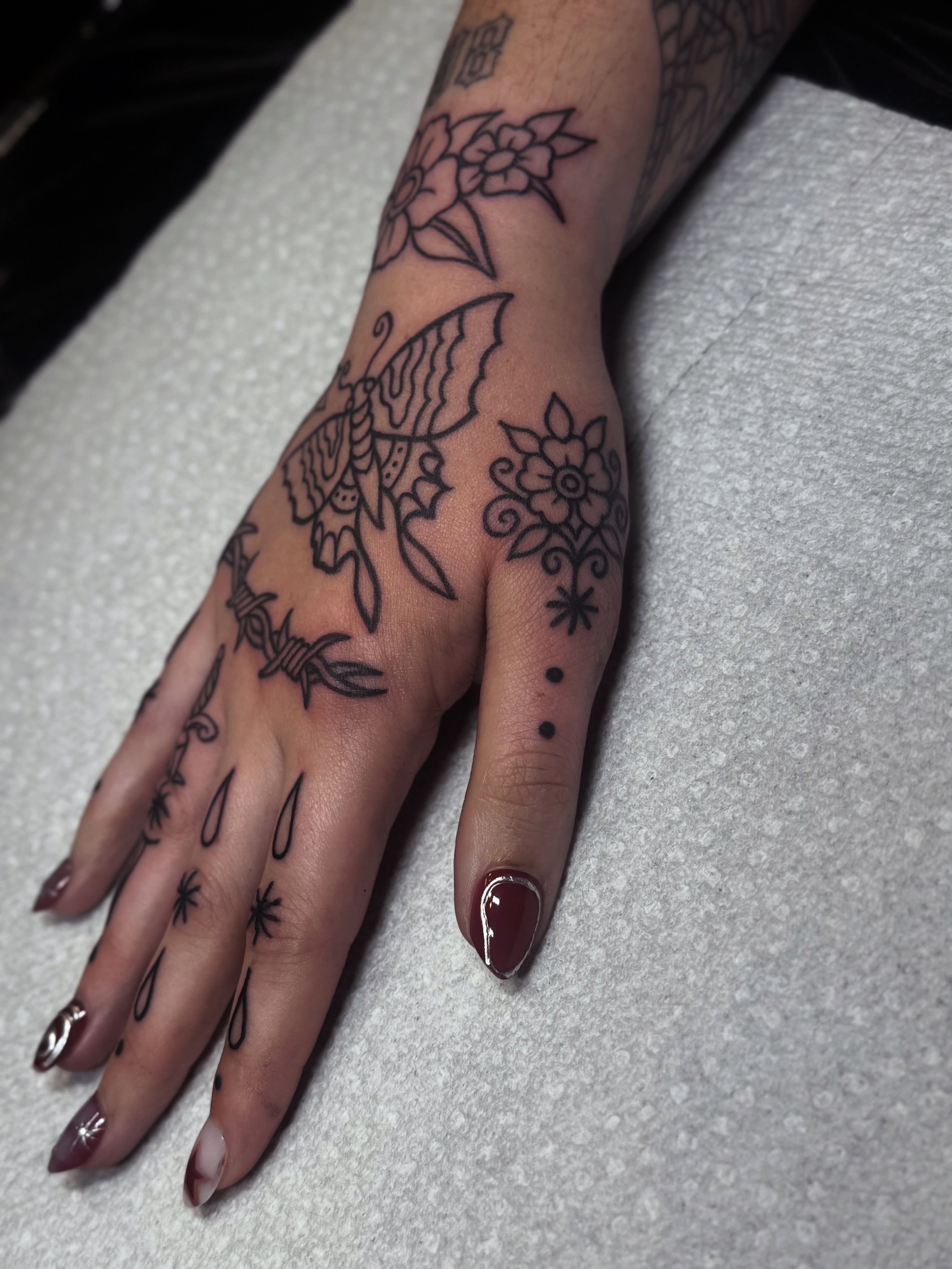 Butterfly and floral black and grey tattoo on the hand by ๐ช๐๐ก๐ก๐ฆ๐ข