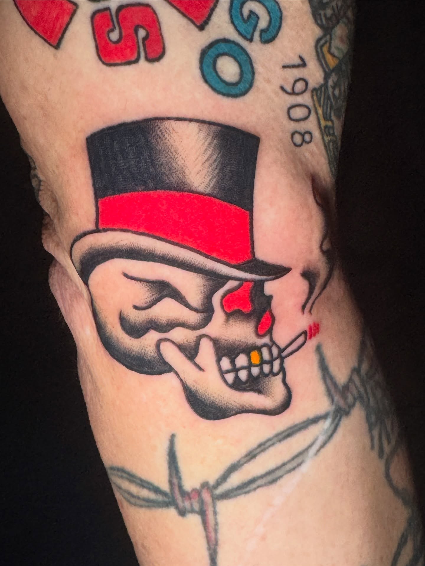 Skull wearing top hat American traditional tattoo on the forearm by Kenneth Gibson