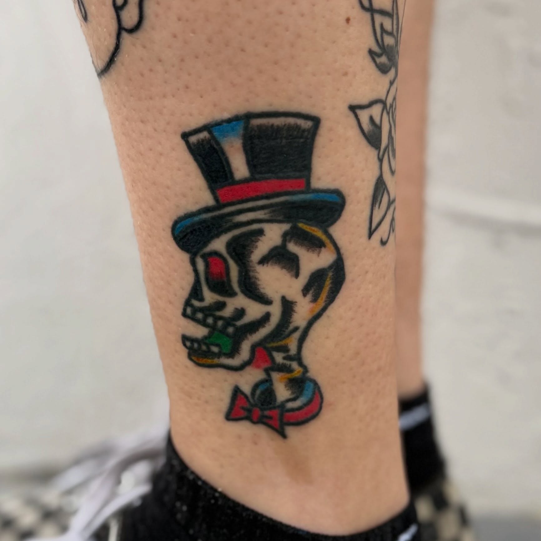Skull wearing top hat American traditional tattoo on the forearm by Camilo