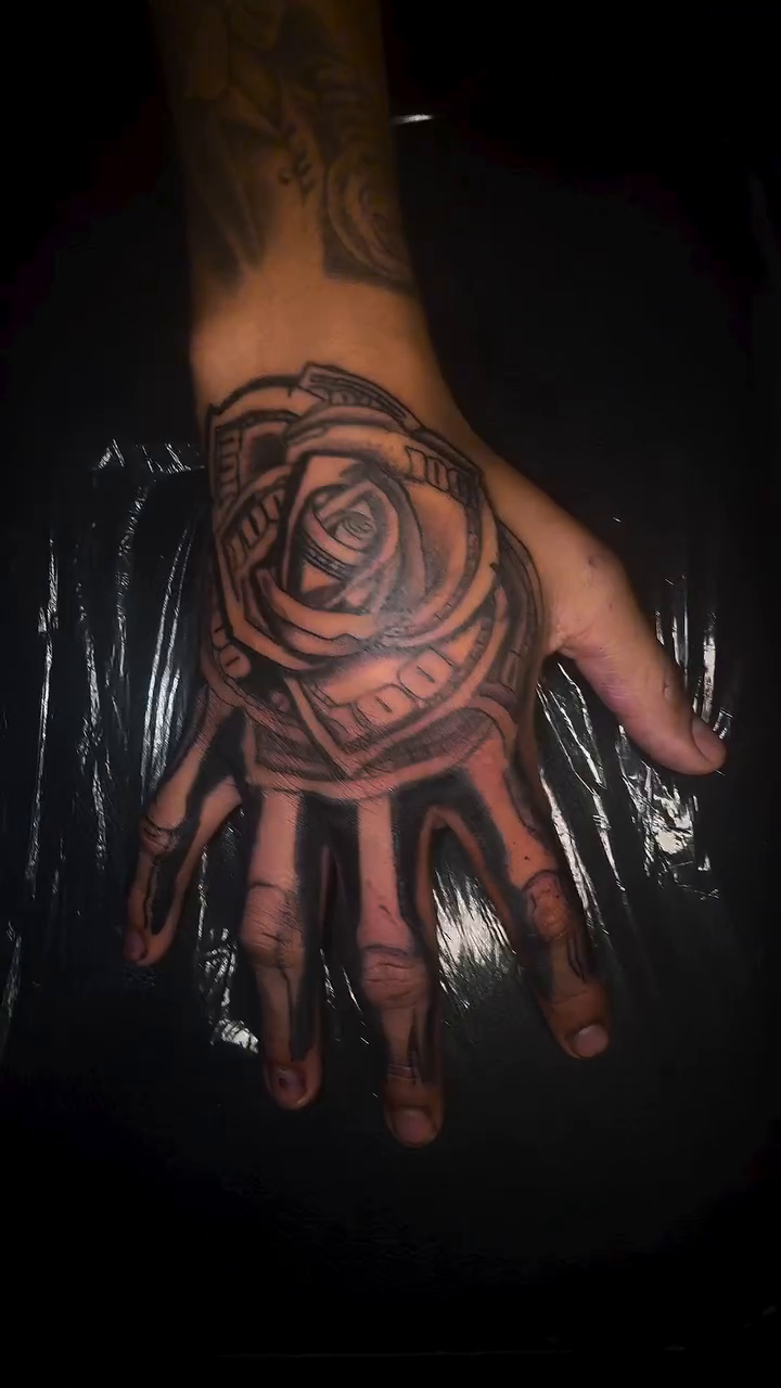 Rose surrealism tattoo on the hand by Comet