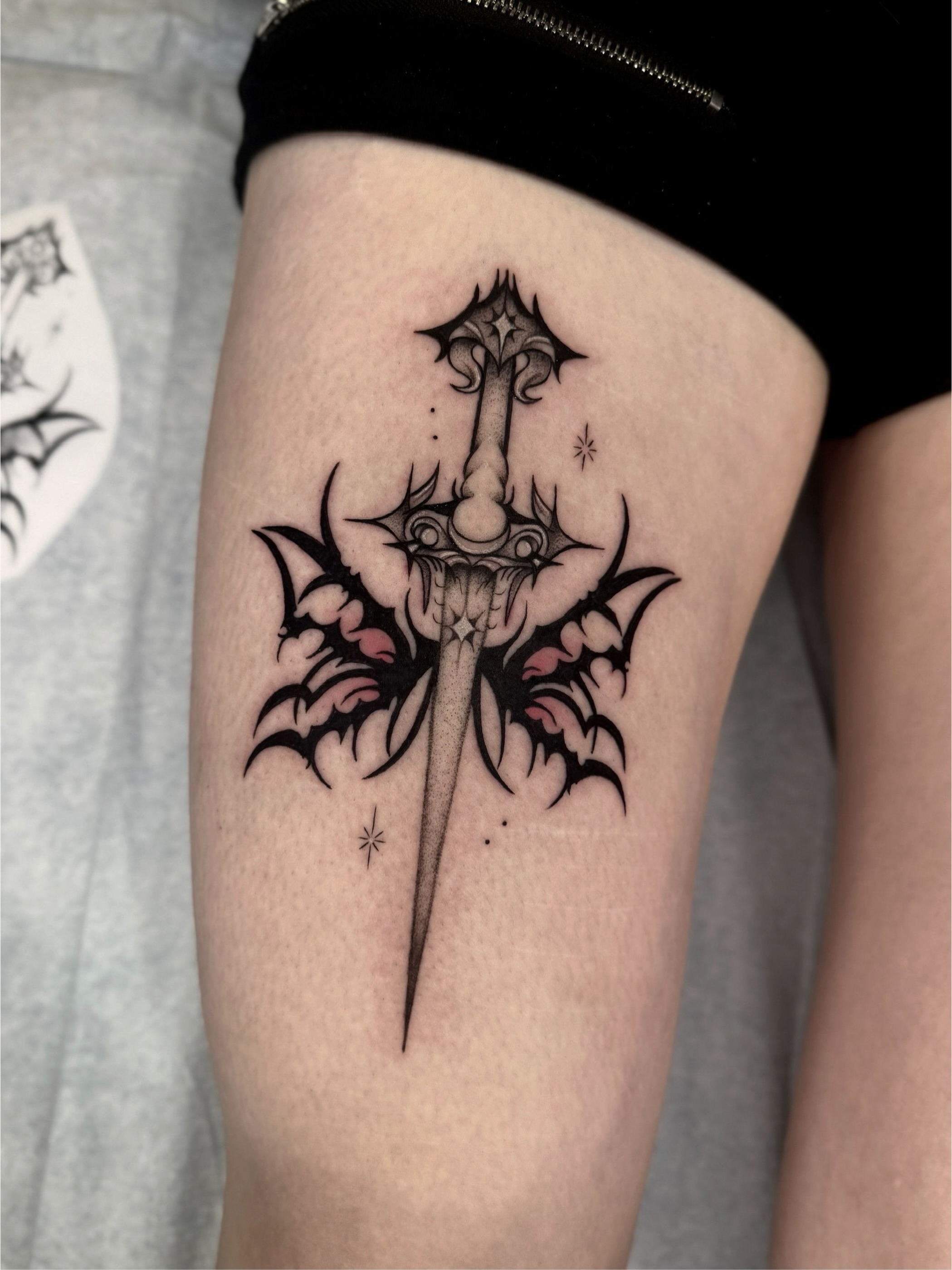 Sword and floral tribal tattoo on the thigh by Kyleigh Shurak