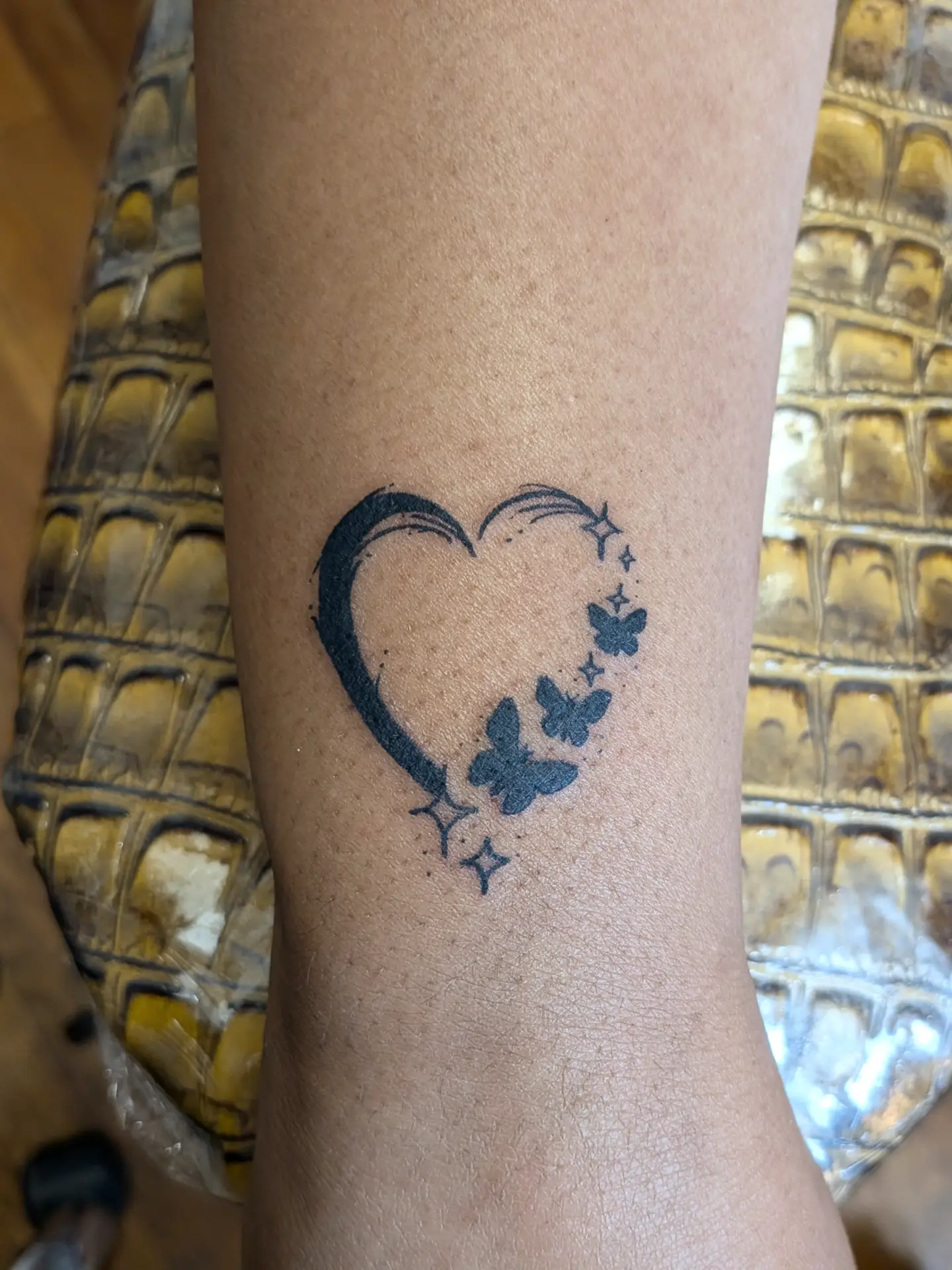Heart with butterflies black and grey tattoo on the forearm by Patricio