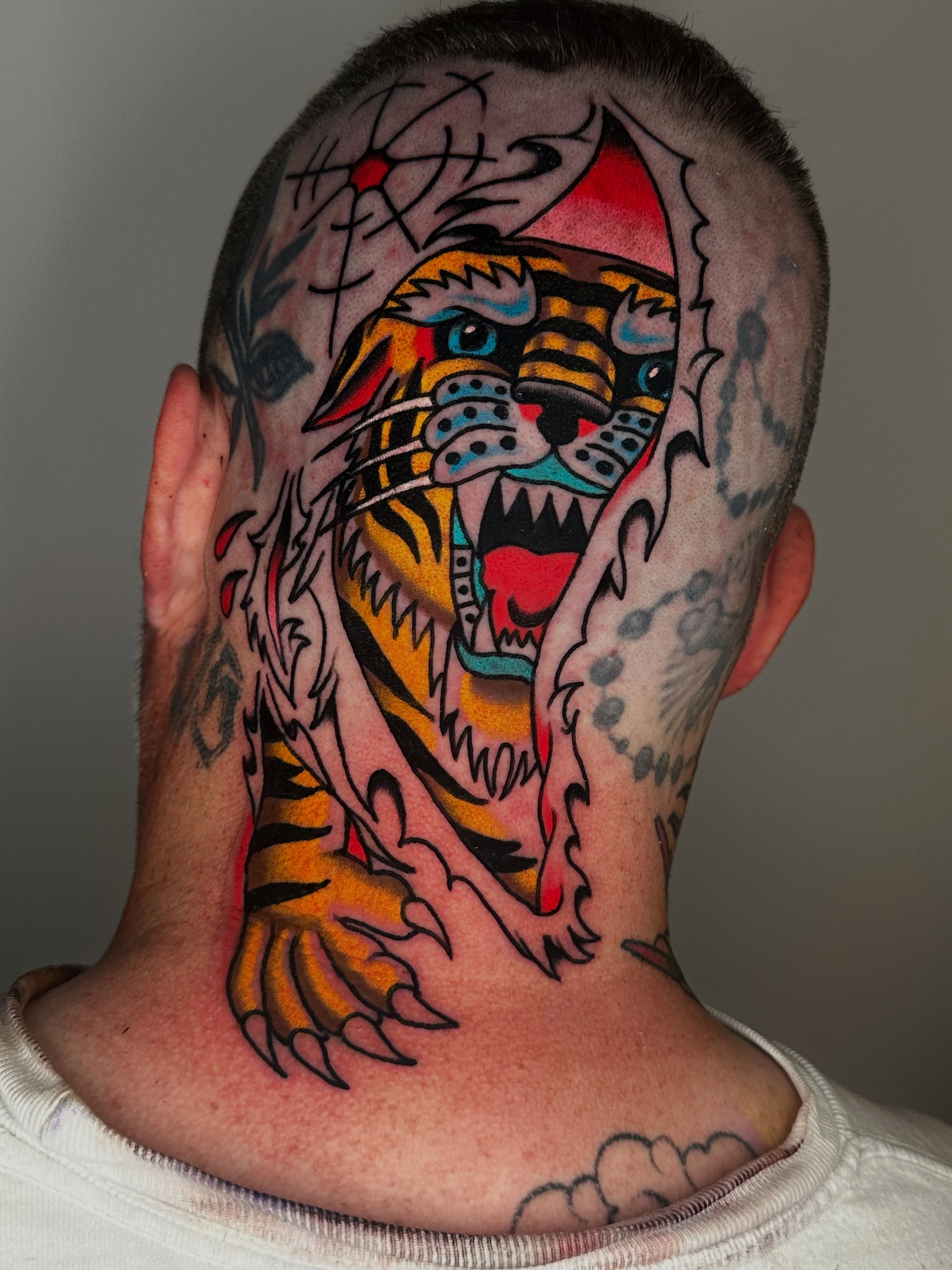 Tiger American traditional tattoo on the neck by Spencer Crawford, Speedway, Indiana