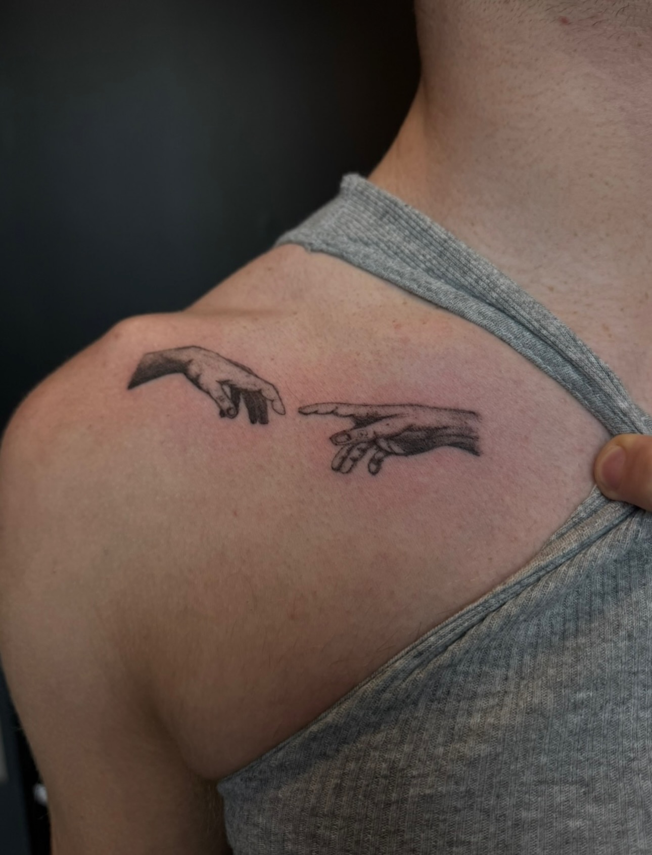 Hands black and grey tattoo on the shoulder by Ryleigh Benjamin