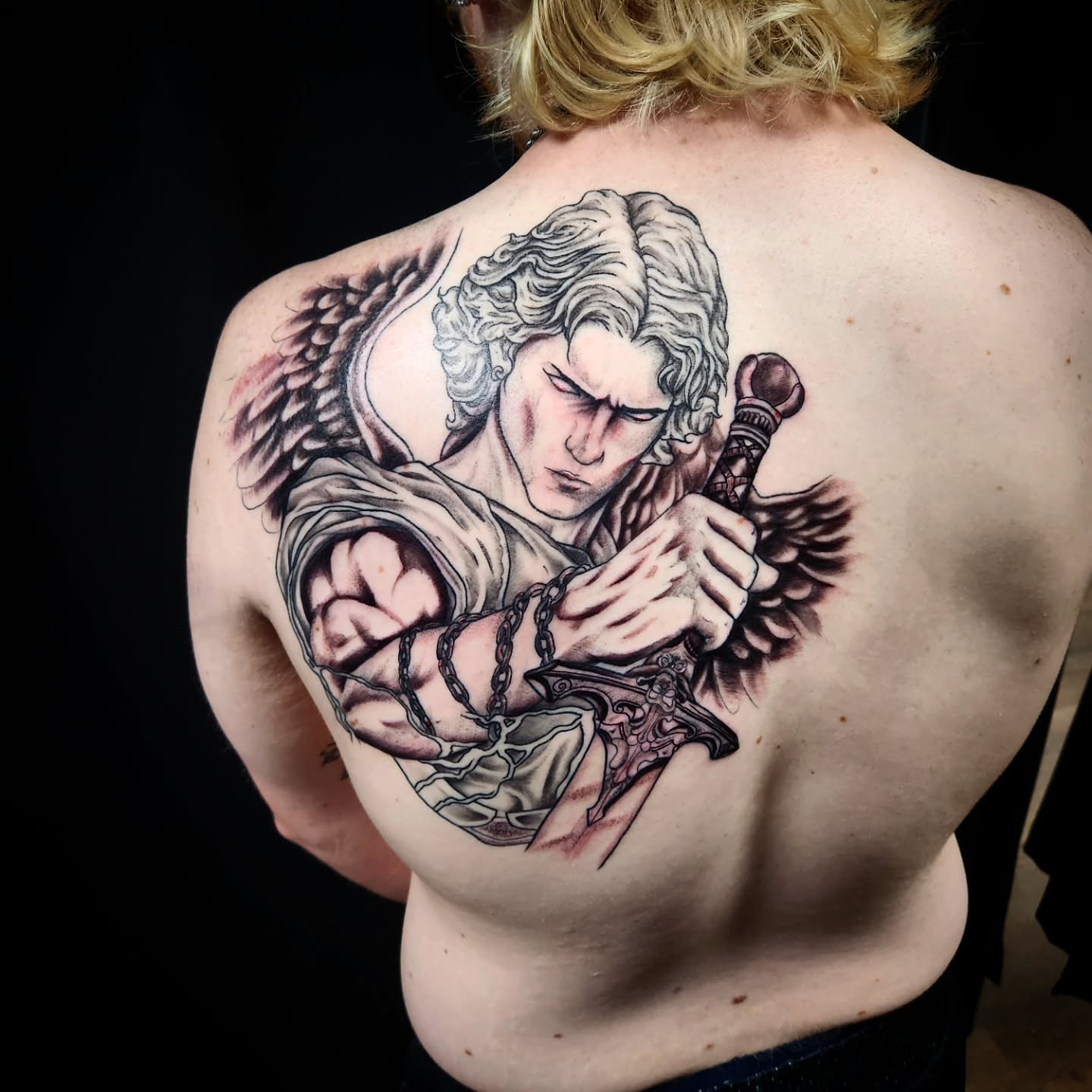 Angel breaking chains realism tattoo on the back by Eric Richards