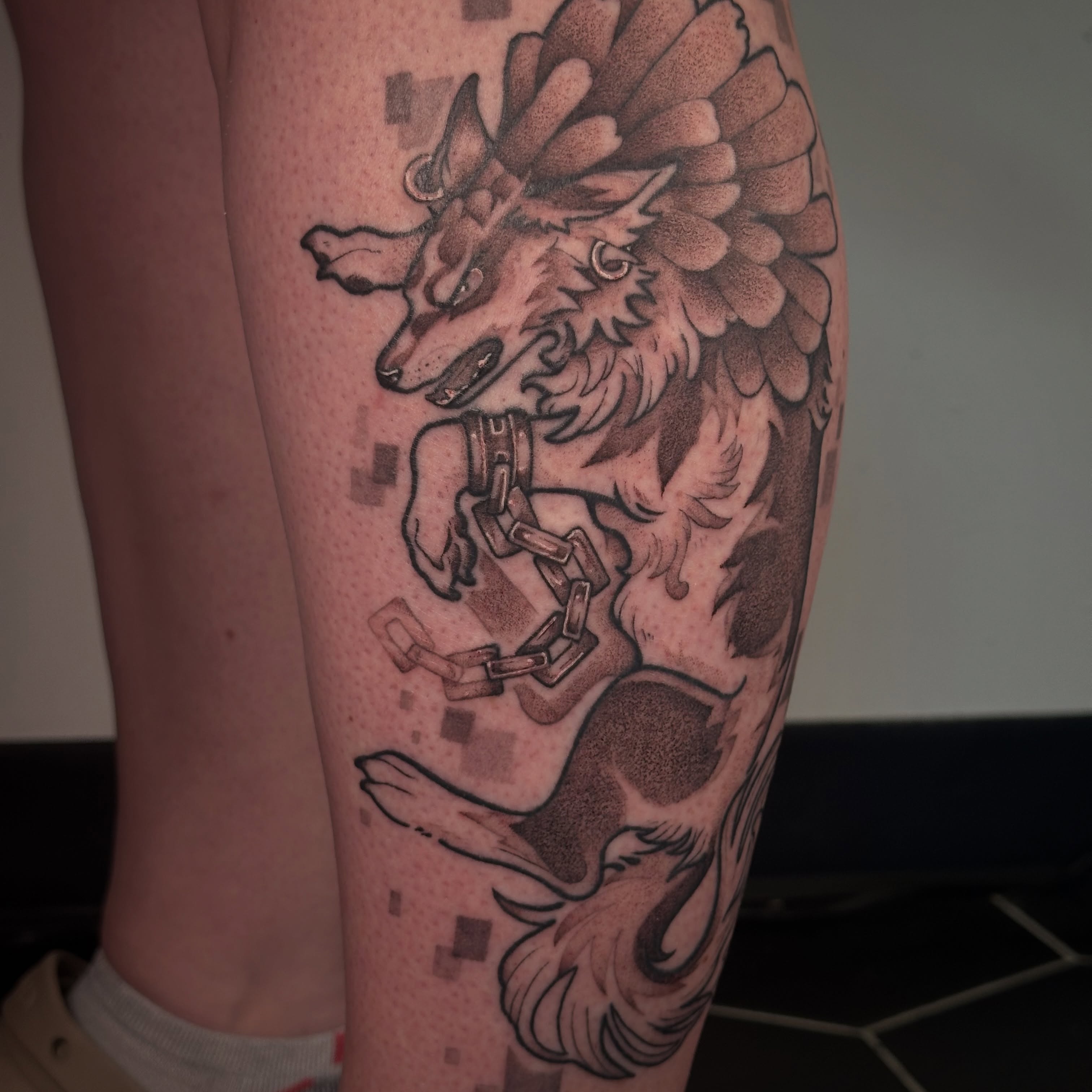 Wolf with chains black and grey tattoo on the thigh by TATTOOLIZARD (James)