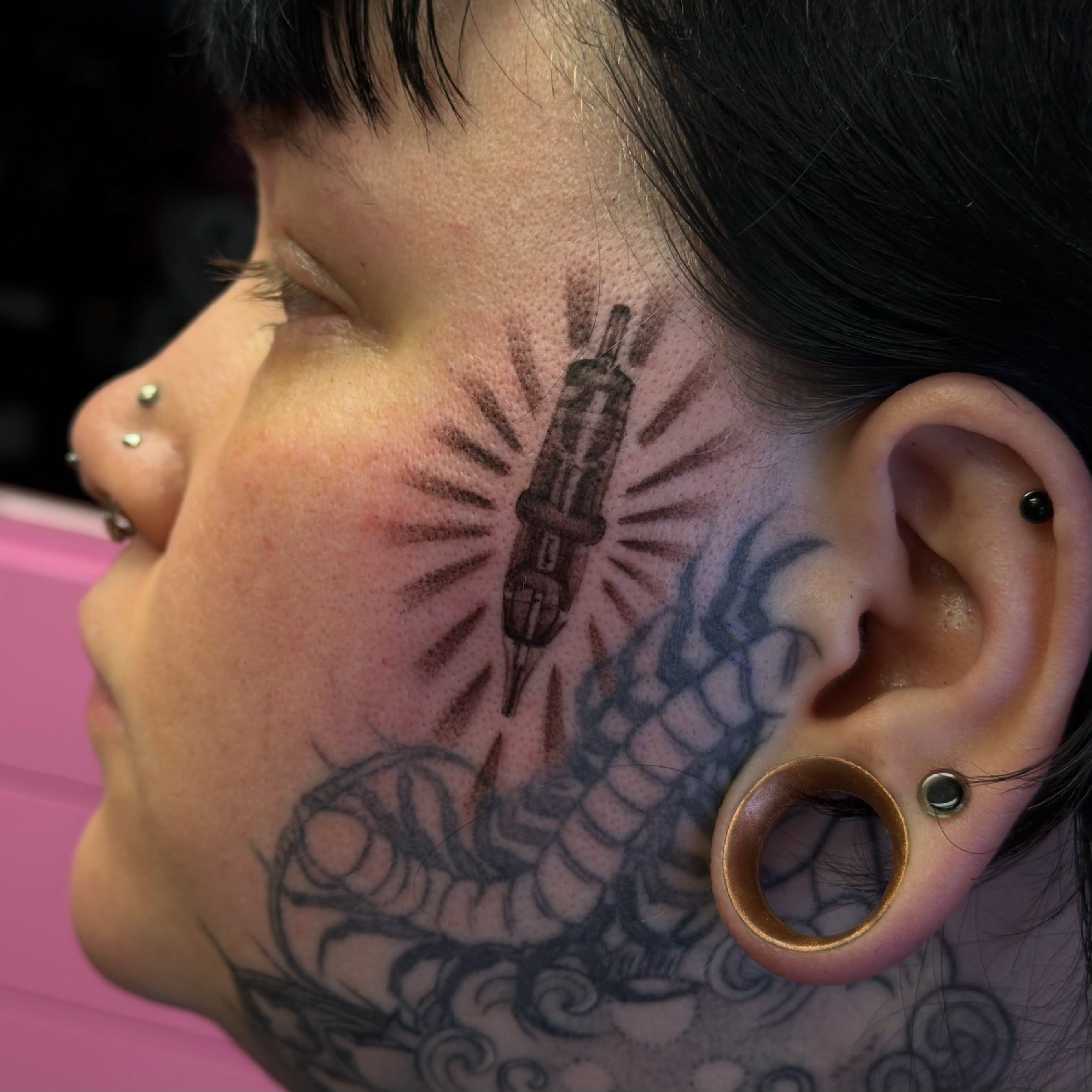 Snake and syringe black and grey tattoo on the neck by Joe Cruz