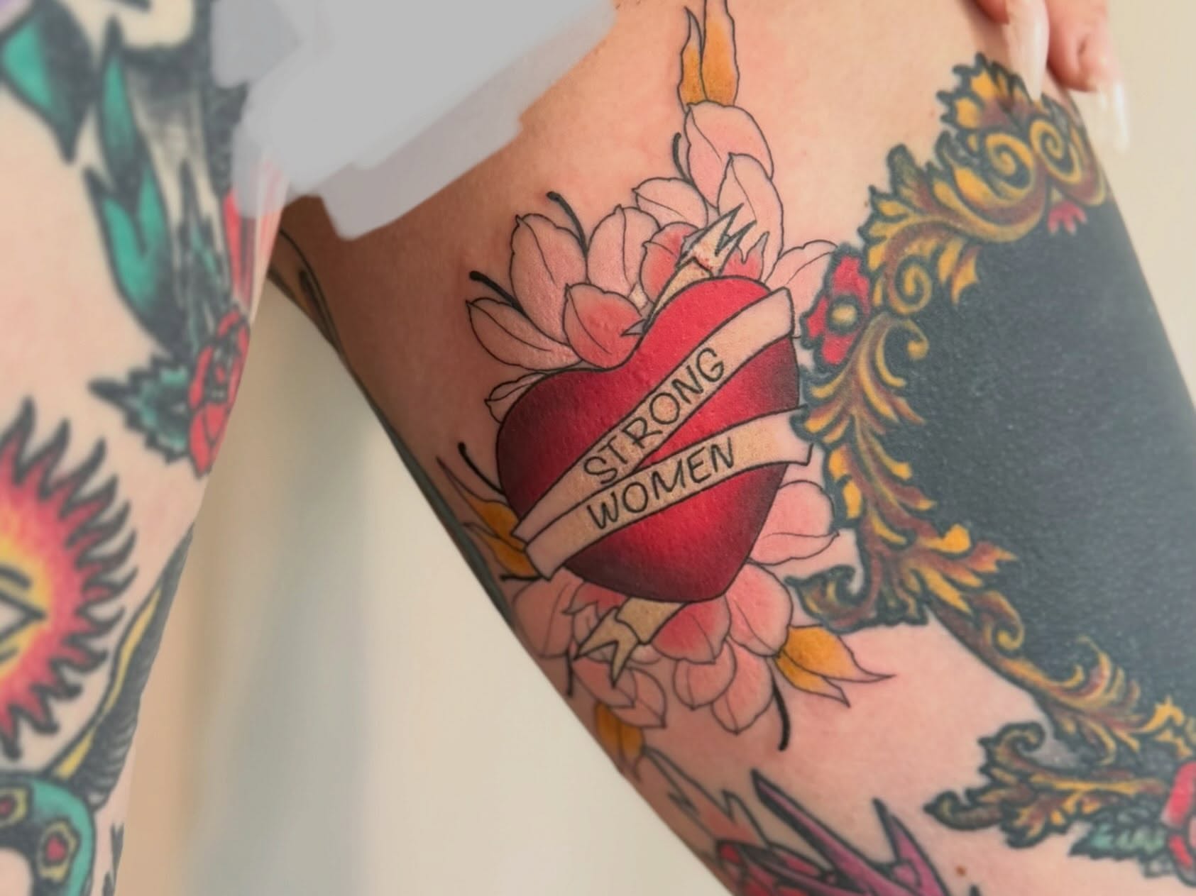 Heart with ribbon American traditional tattoo on the forearm by 🖤🥀🐉Taylor Nichole👻🌙✨️