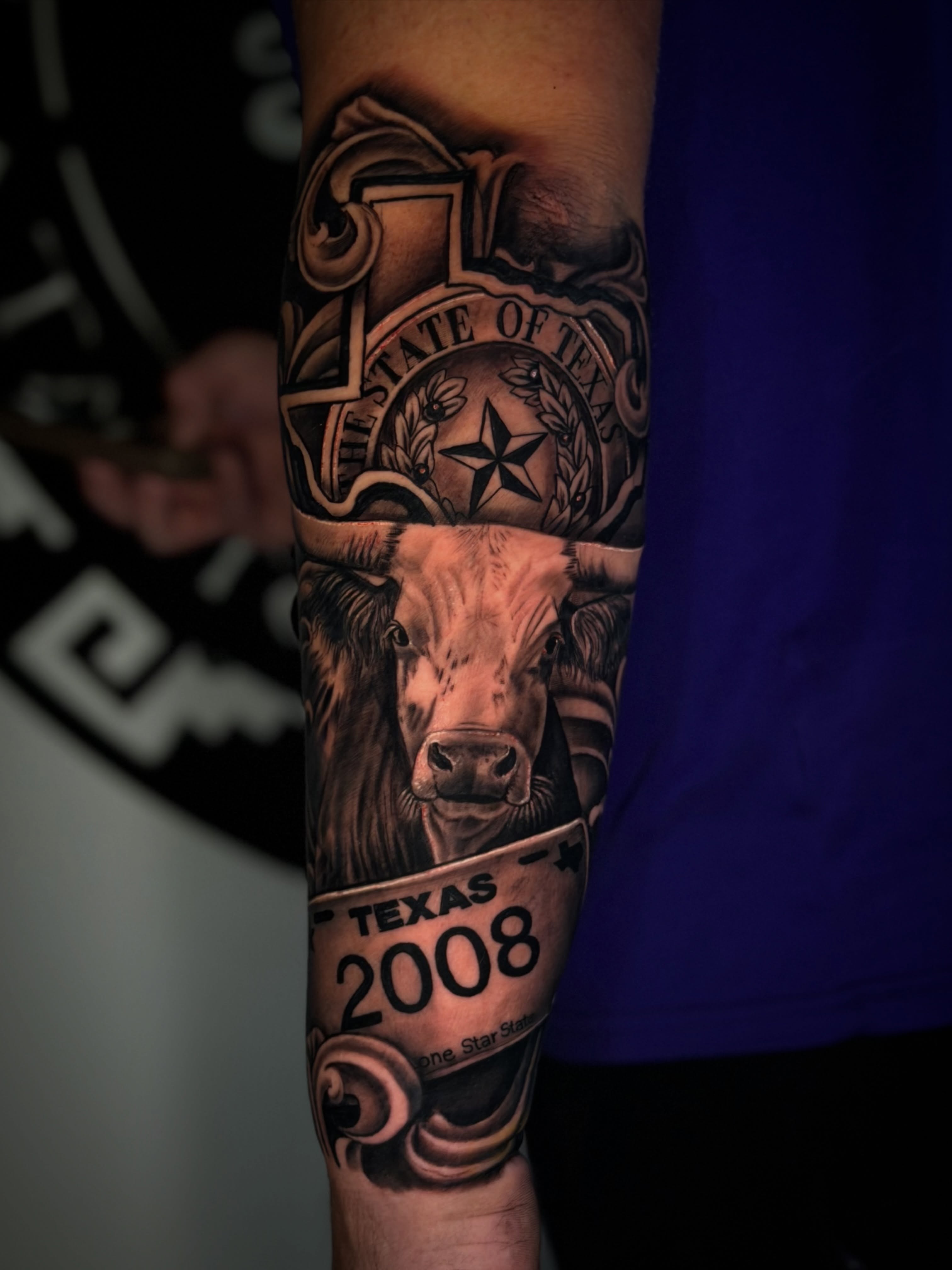 Cow and Texas license plate realism tattoo on the forearm by Dreamchaserink