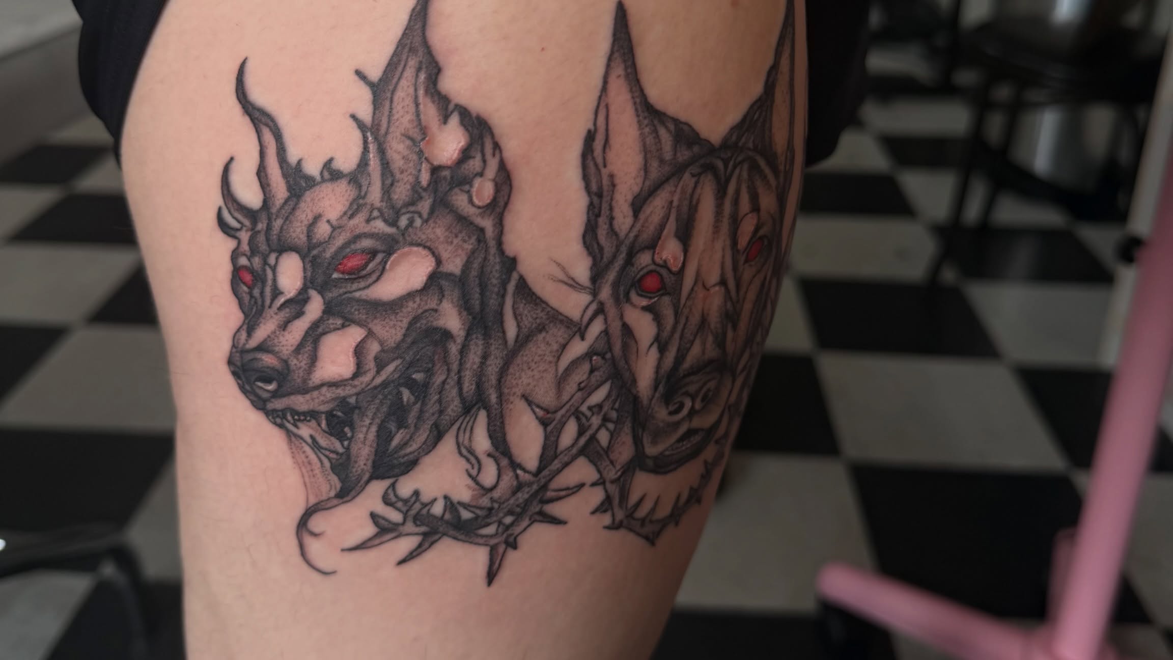 Demon heads dark realism tattoo on the thigh by Nina Nichole