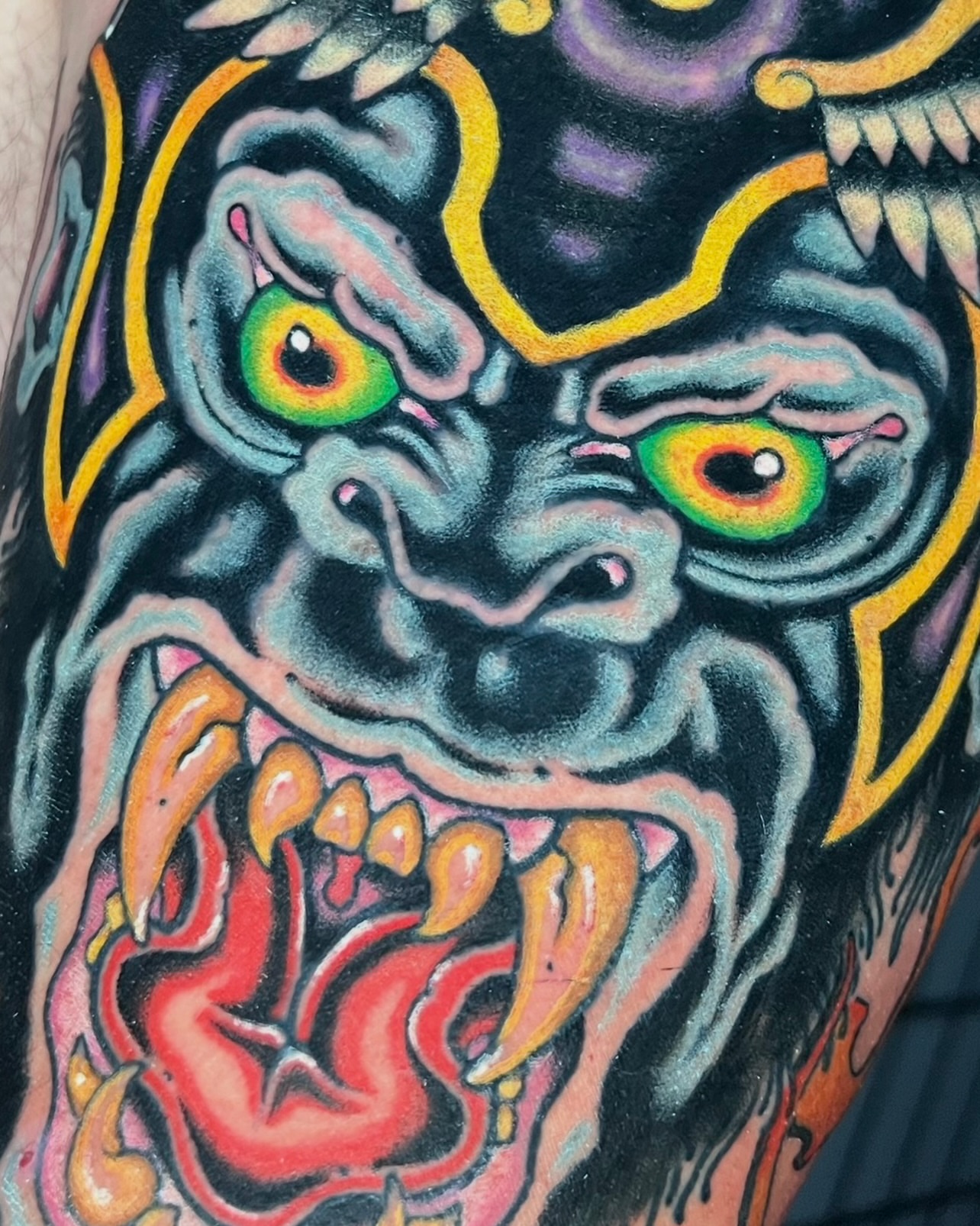 Demon face American traditional tattoo on the forearm by Jade Napier