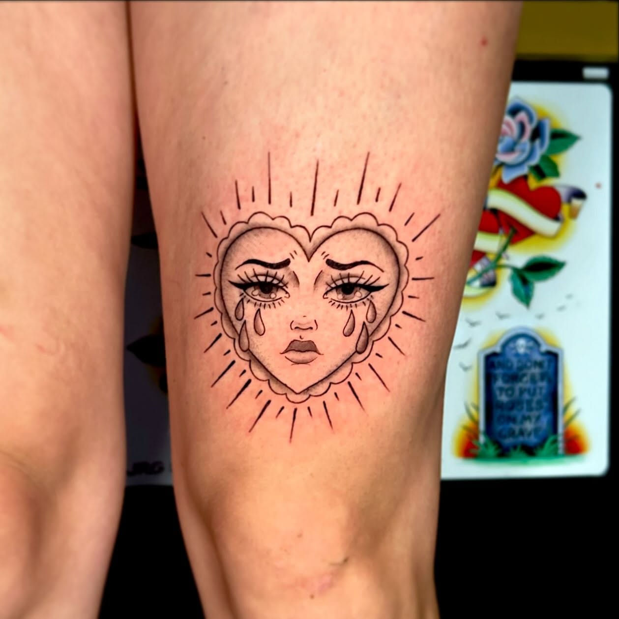 Heart with crying face American traditional tattoo on the thigh by 🕸🖤Kass🖤🕸