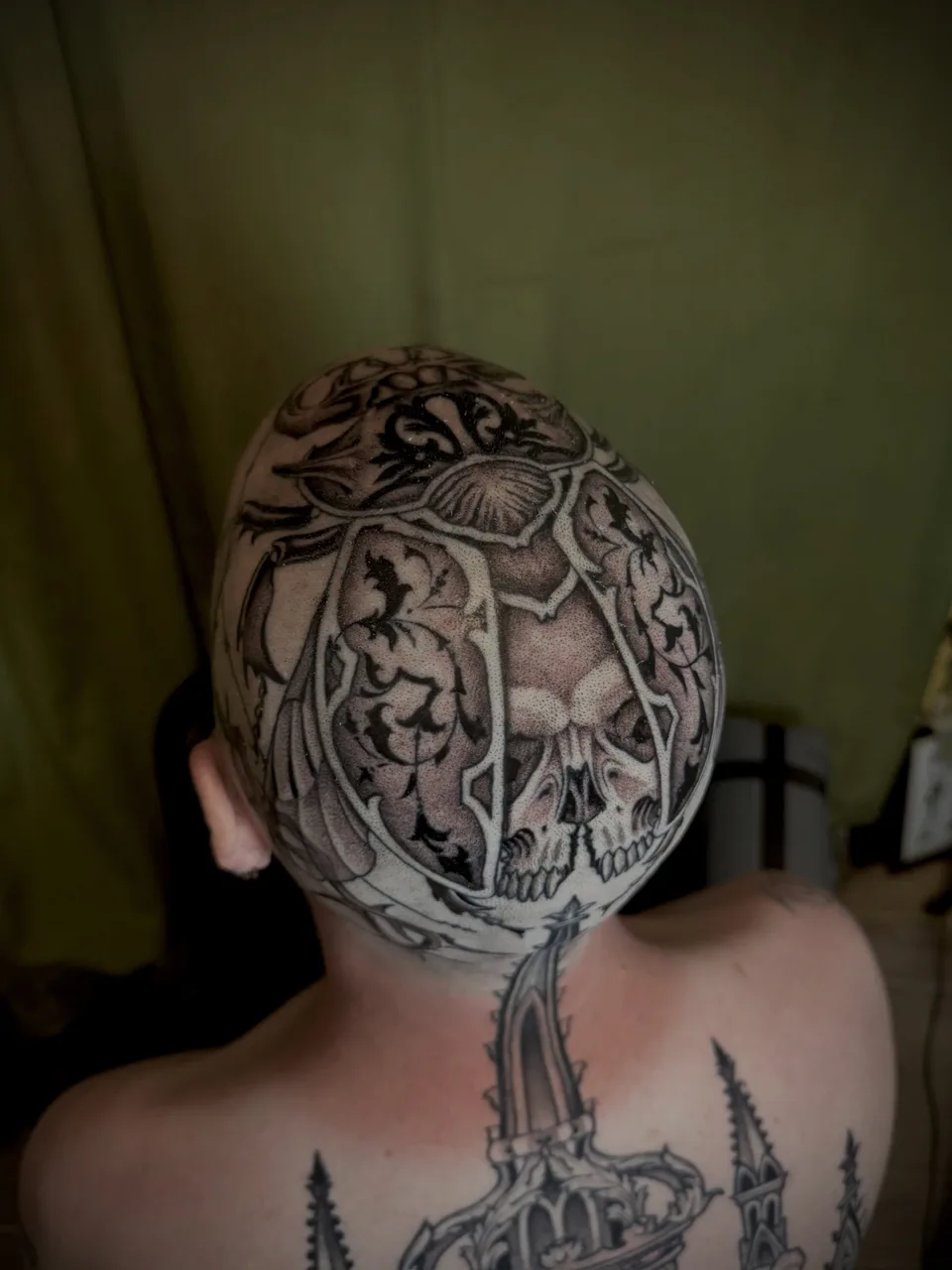 Skull and floral ornamental tattoo on the head by Lauren Vandevier