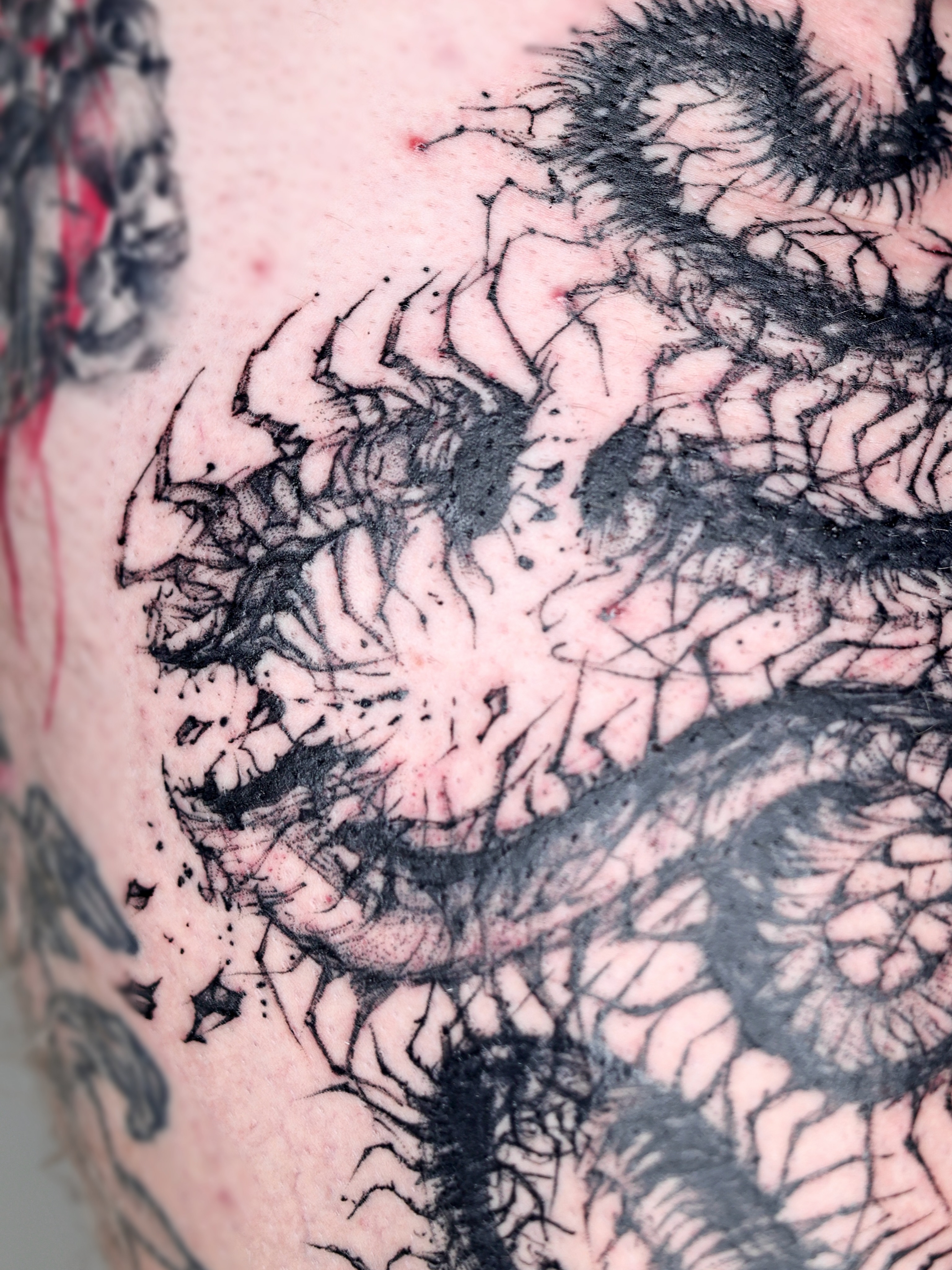 Abstract organic form black and grey tattoo on the thigh by Abi