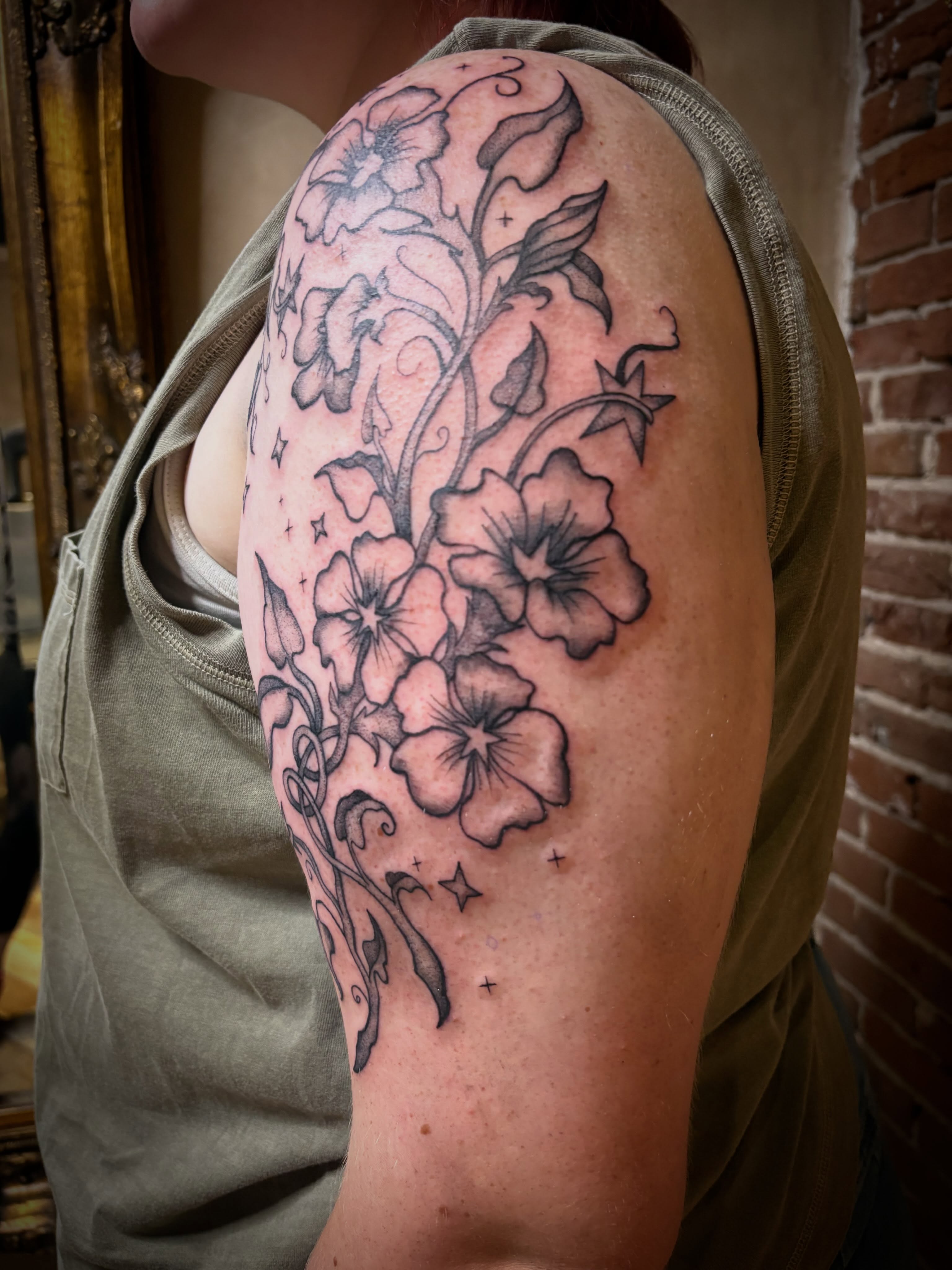 Floral bouquet black and grey tattoo on the shoulder by Tattoo Artist, Kansas City, Missouri